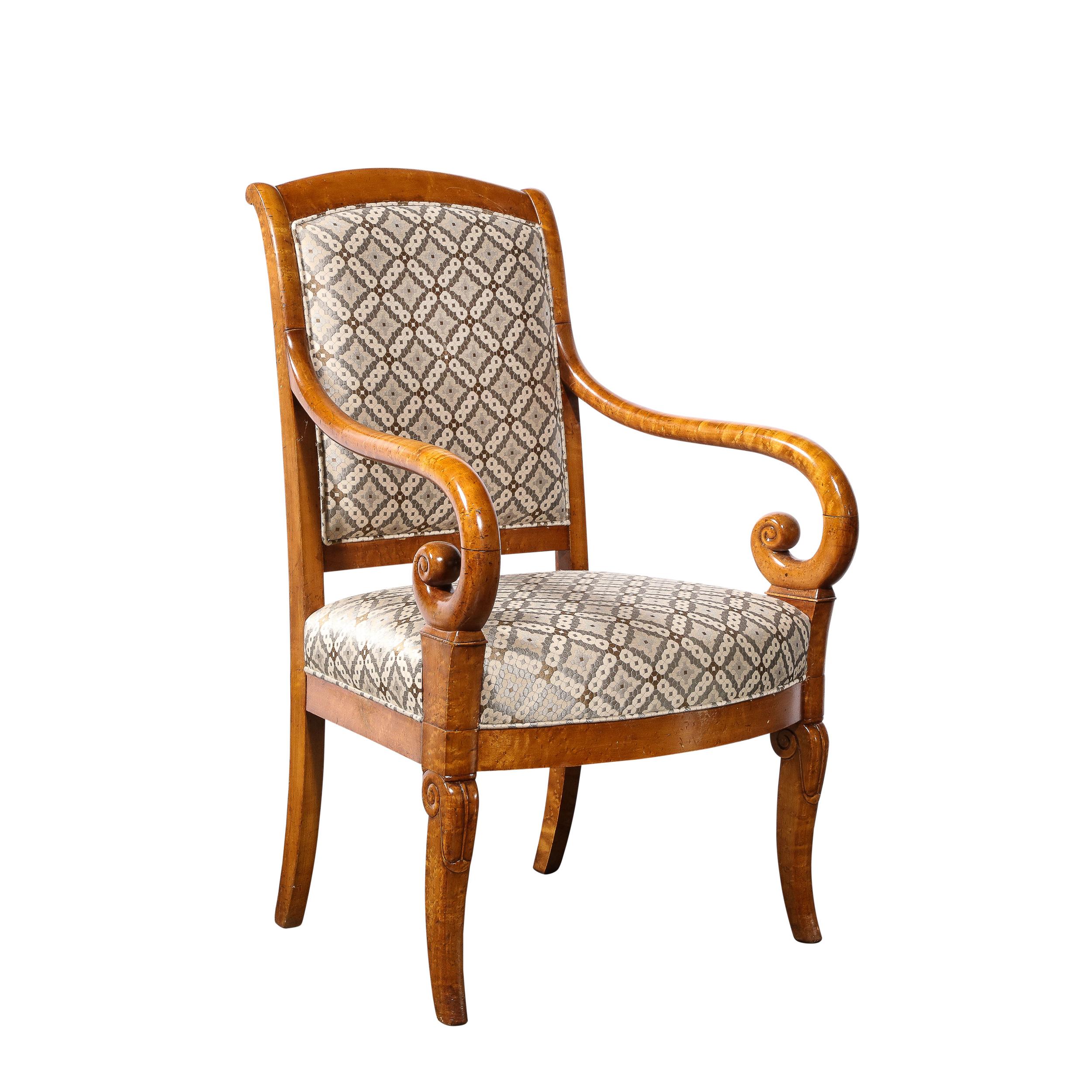This elegant and sculptural pair of Biedermeier arm chairs were realized in Austria circa 1880. Realized in a stunning burled elm- showcasing the sumptuous natural grain of the wood- they feature stylized cabriolet style legs with scroll form