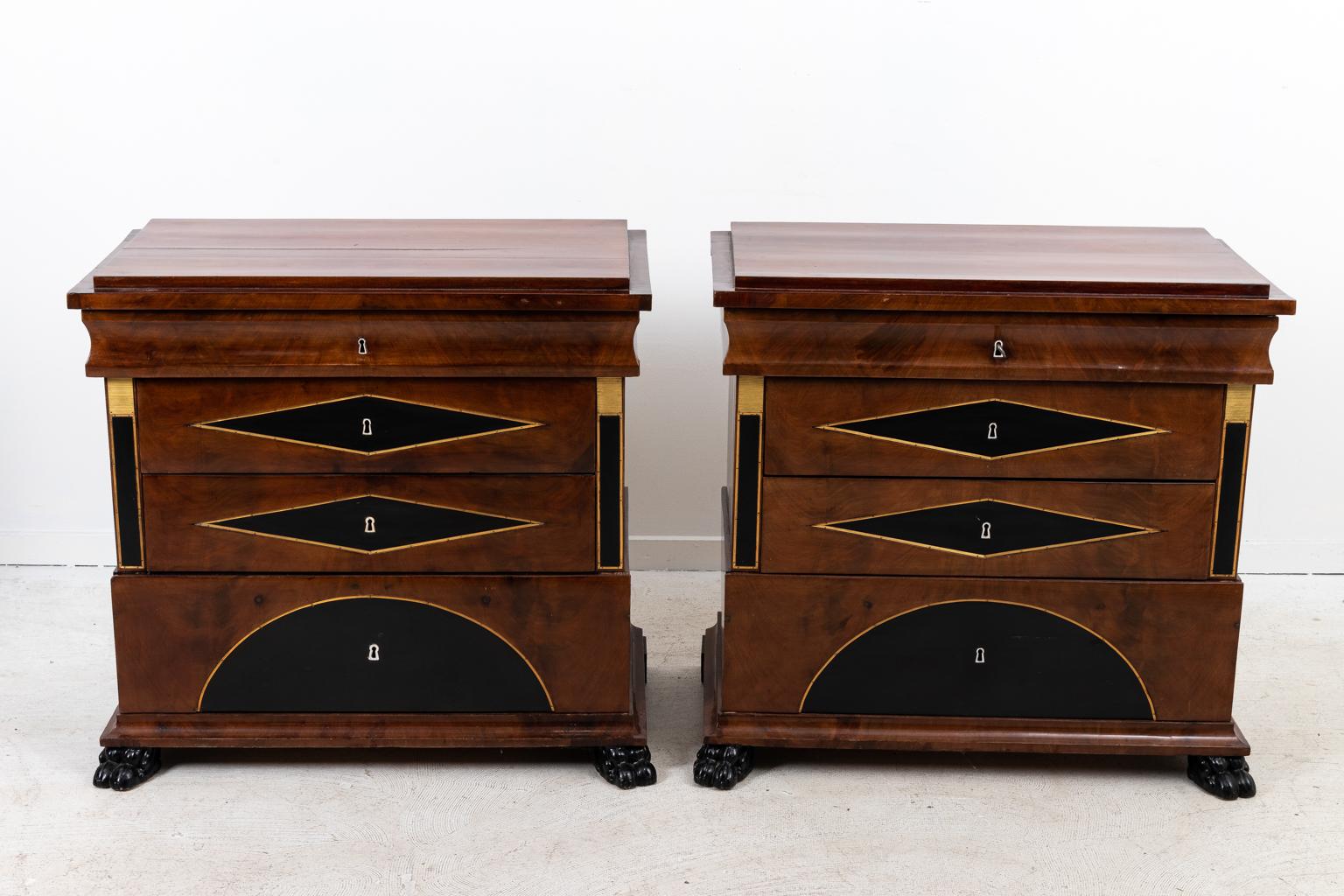Pair of Biedermeier chests with brass inlay, three drawers, and French polish. Please note of wear consistent with age. The feet have been replaced.