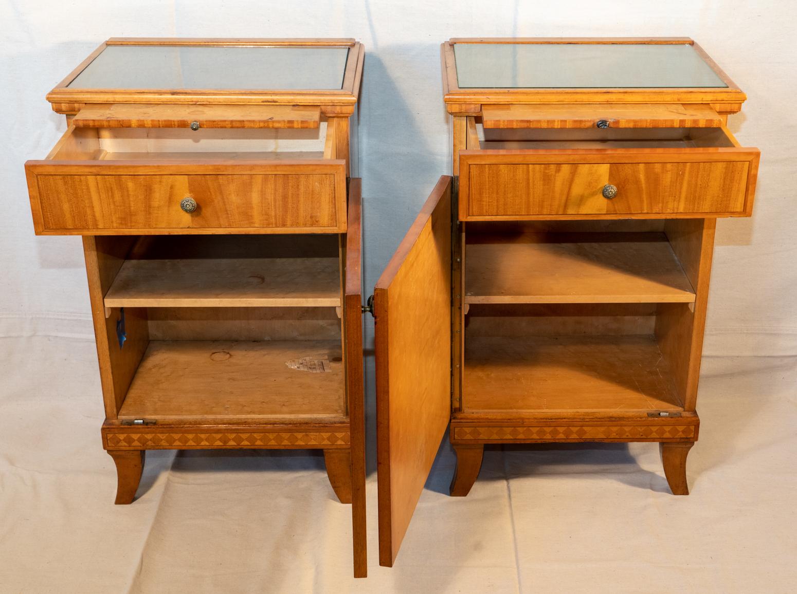 Pair of Biedermeier style nightstands, circa 1920. Art Deco Biedermeier style.
Beautiful light wood with crossbanding and line inlays. Built very solid with good drawer construction and substantial vertical hinges.
A matched pair. Different color
