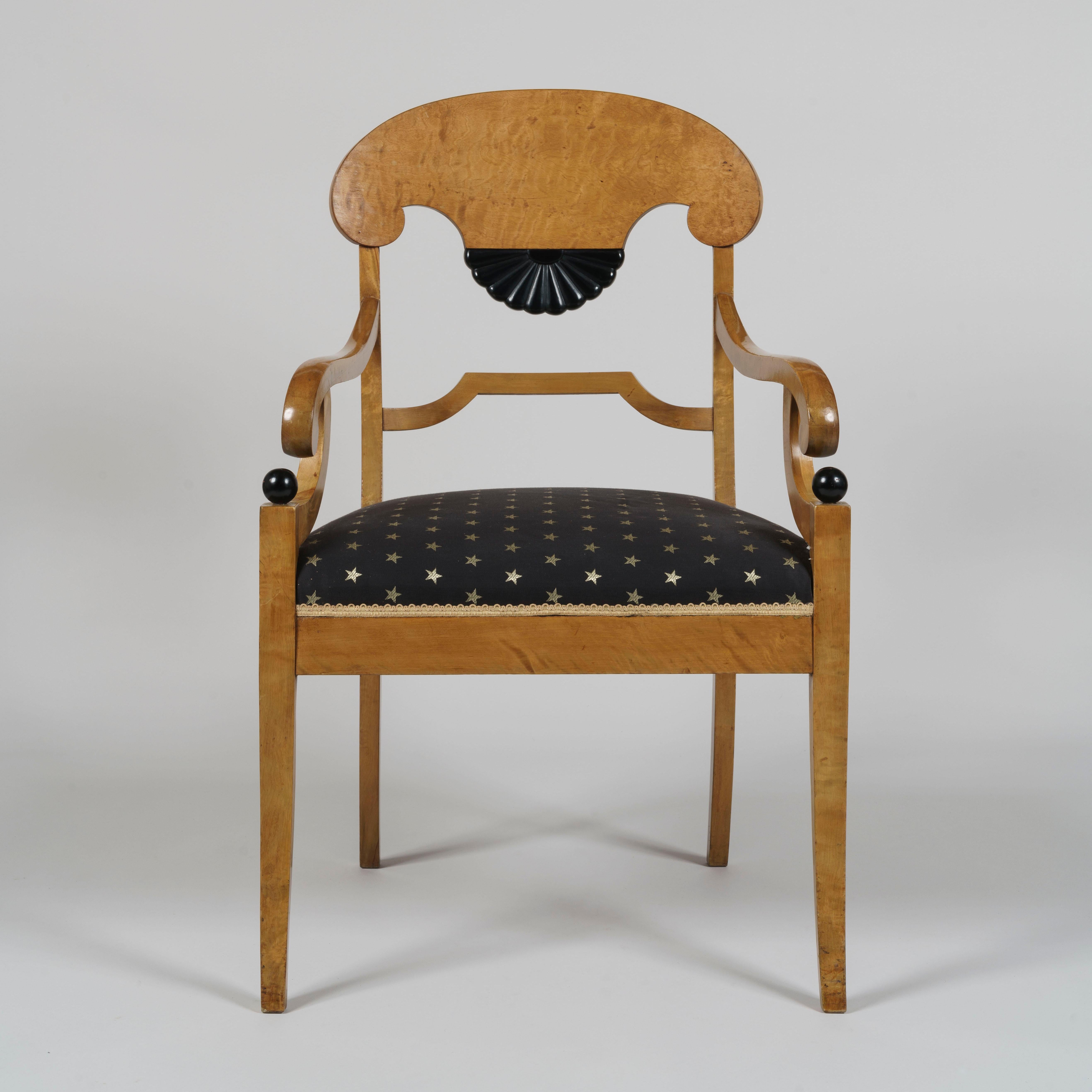 A fine pair of Biedermeier style satin birchwood armchairs

The plume shaped top rail extending to midway between the stiles, terminating in an ebonised fan shaped splat, above a stepped stretcher. The scrolling arms supported on C scrolls with