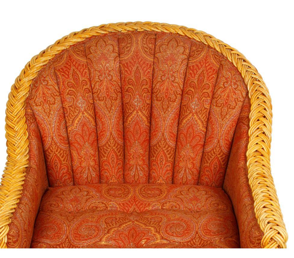 A pair of Bielecky wicker armchairs with upholstered, tufted seat and back.