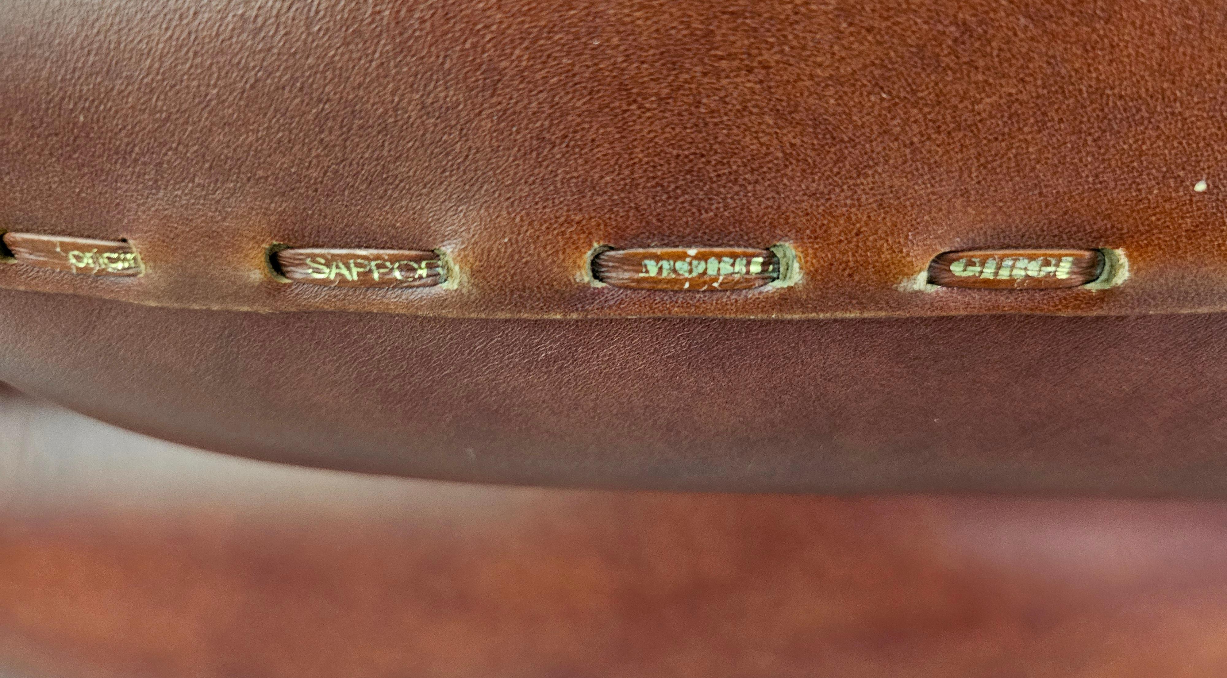 Set of large and soft Italian lounge chairs. Incorporating lines and round shapes the sofa is extremly comfortable and well designed.Signed.
Designed by Sapporo for Mobil Girgi in the 1970s.
Original vintage cognac leather with side stitching