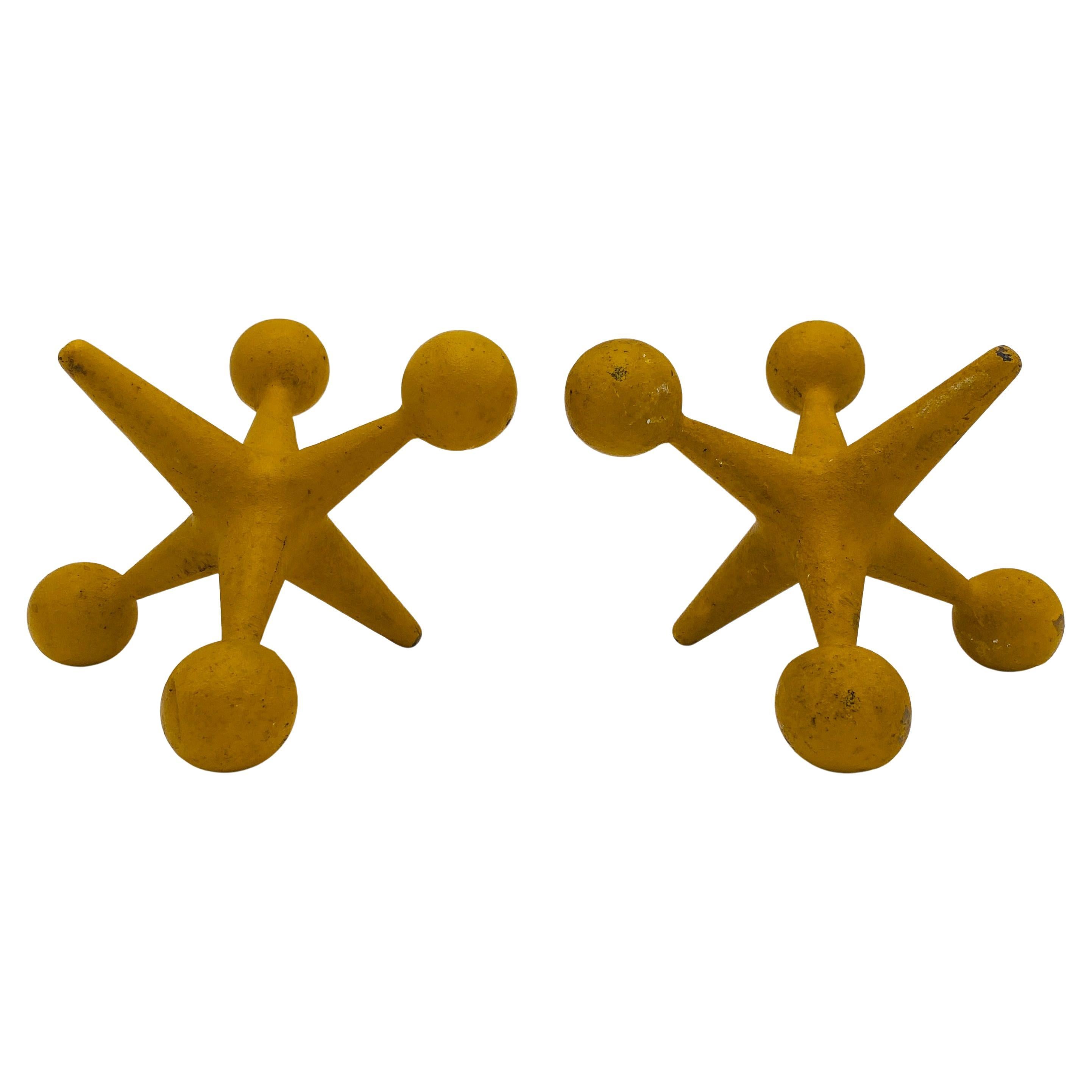 Pair of Bill Curry Jacks or Jax bookends. These are truly mid century modern icons and vintage must haves for any home. These are Design Line Model J-1 Jacks, made in California. They are cast iron in a yellow or mustard color that are a great pop