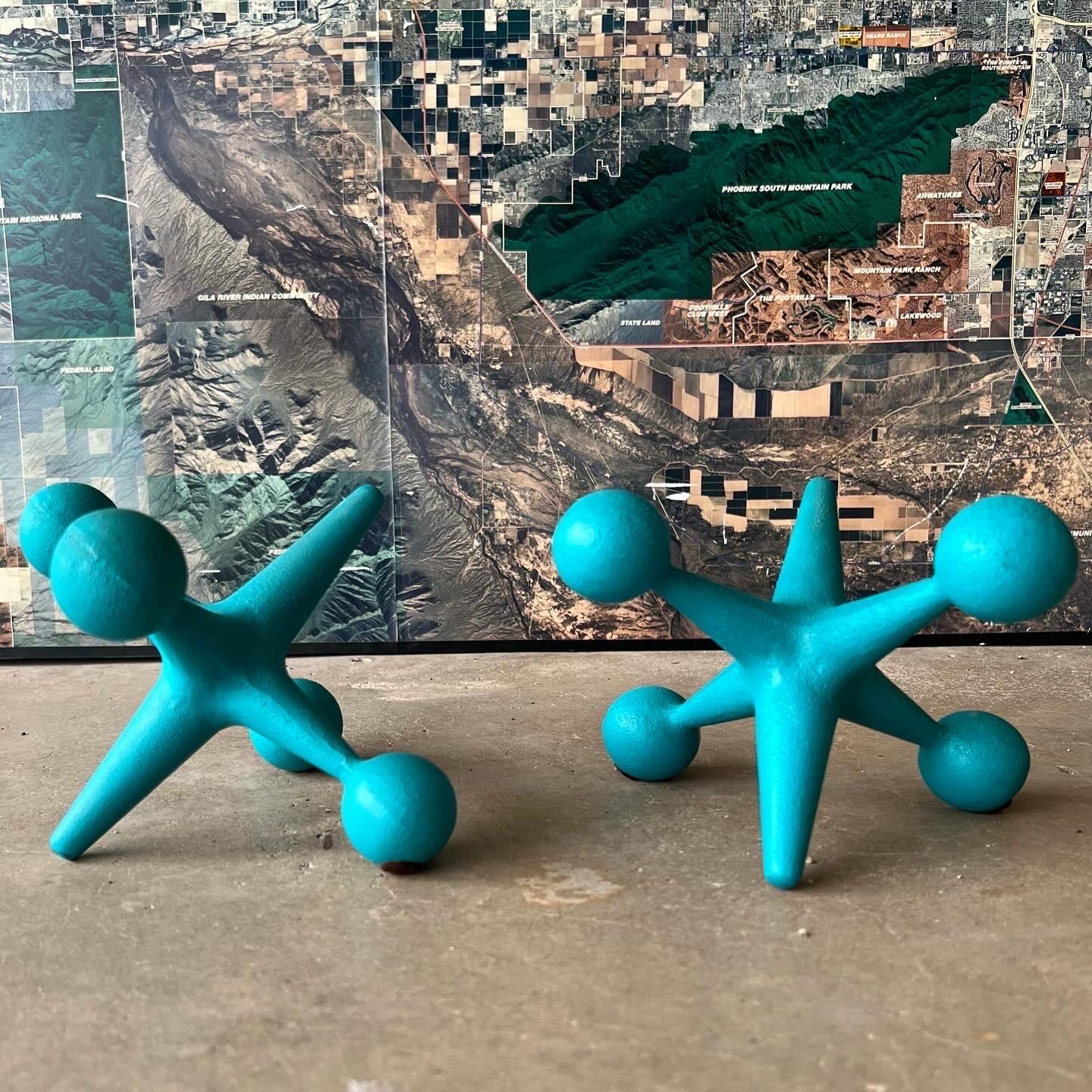 Pair of Bill Curry Jacks (Jax) bookends. These are truly mid century modern icons and vintage must haves. These are Design Line Model J-1 Jacks, made in California. They are cast iron in a turquoise or teal color that are a great pop of color. I am
