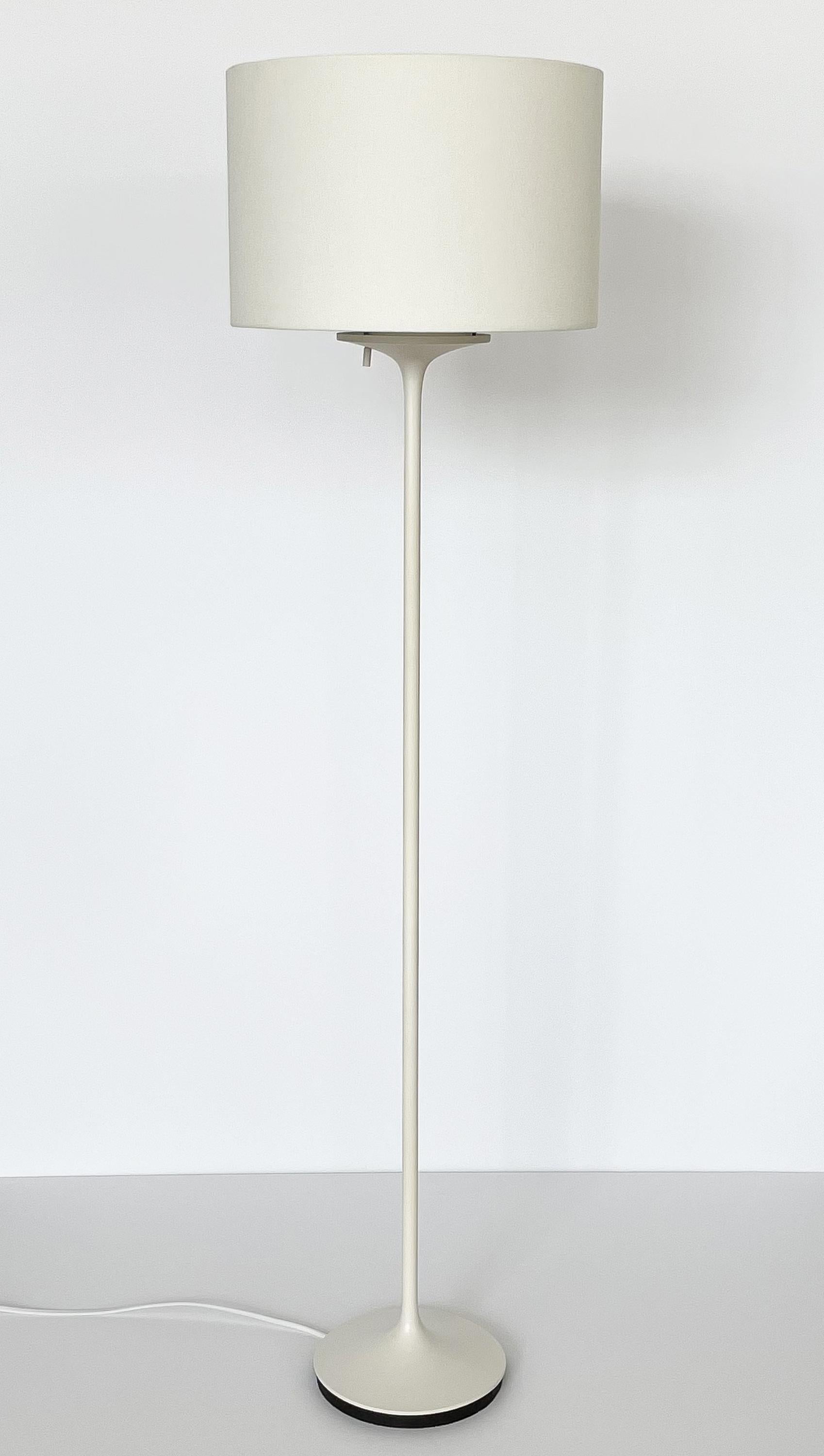 Pair of white Stemlite floor lamp by Bill Curry for Design Line, circa 1960s. Model D-7. Tulip shaped bases are die cast, machined and handcrafted to form an elegant seamless contour. Coordinating white linen shades are capped with a white