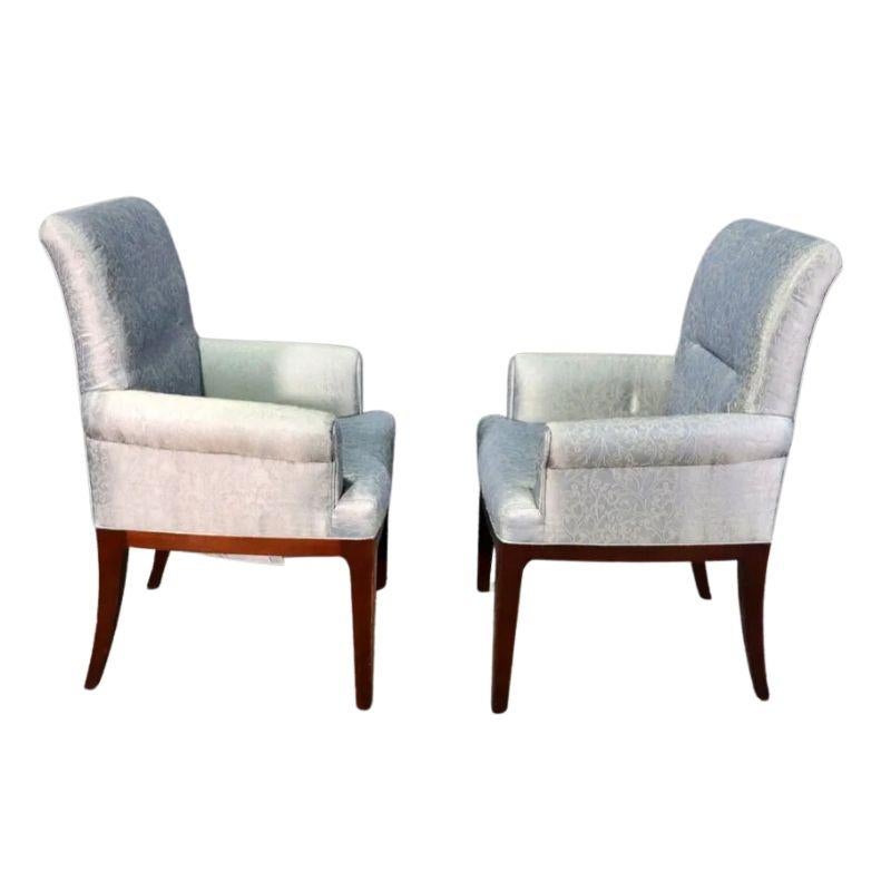 A pair of Bill Sofield for Baker Furniture contemporary upholstered arm chairs.  The modern styled chairs with straight backs and slightly flared arms are upholstered in a beautiful slate blue fabric with a light sheen and embroidered with a