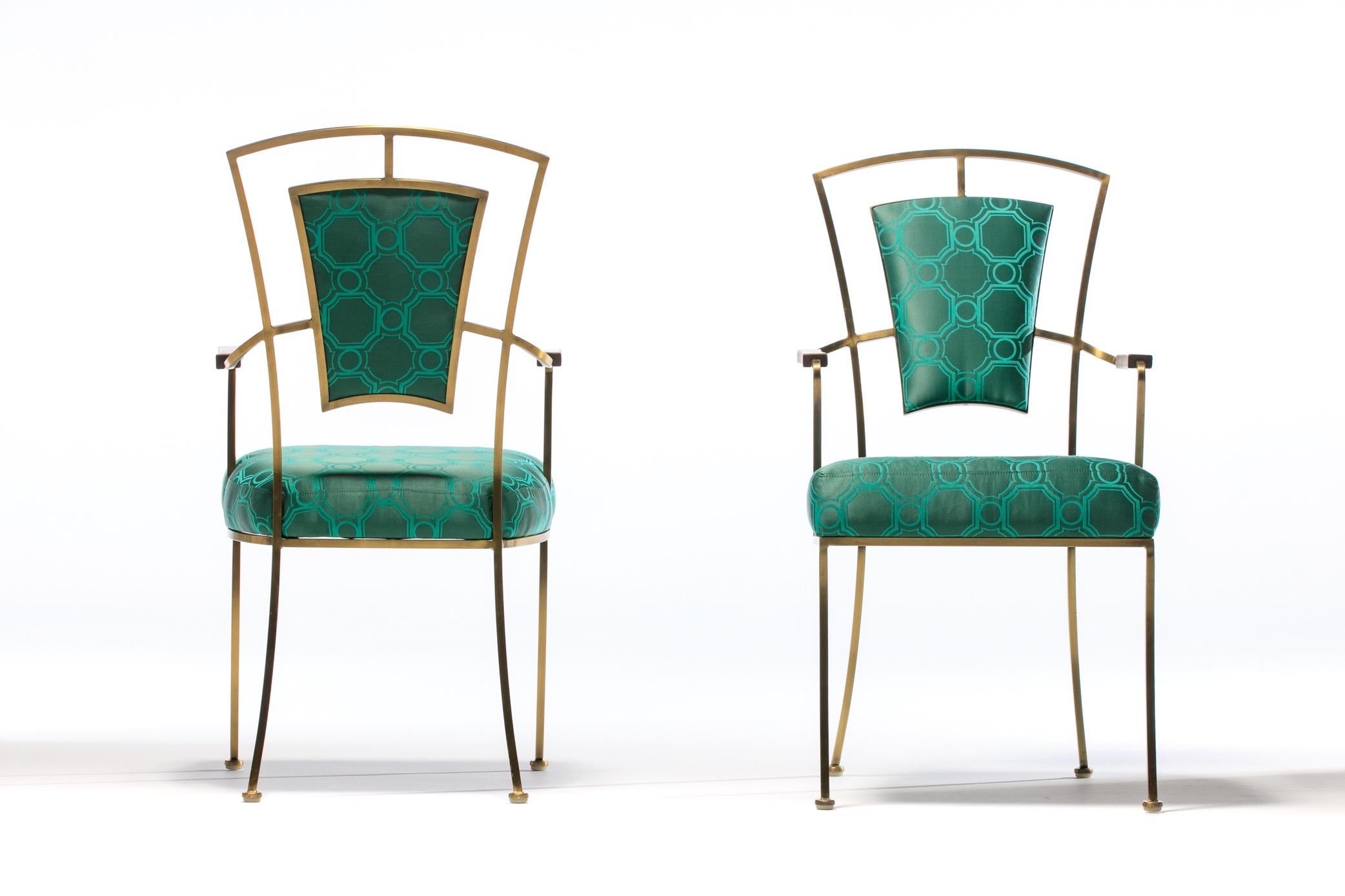 Sourced from a Beverly Hills estate and chic to the nines, this pair of 1960s Billy Haines style Hollywood Regency armchairs feature heavy duty solid brass frames with natural patina, walnut arm rests, and were professionally reupholstered in a Tony