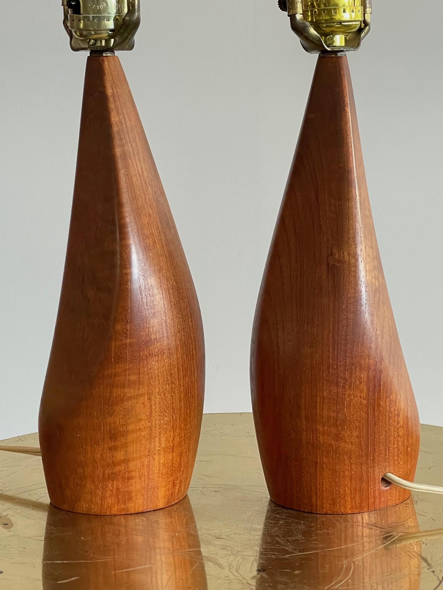 A pair of unusual Danish teak lamps by Ernst Henriksen, signed, circa 1960s. In very good condition with beautiful graining.
 