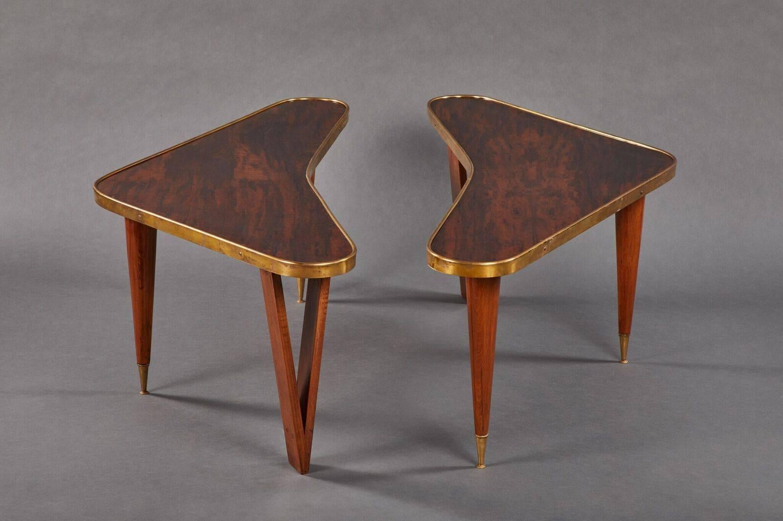 Exceptional pair of curvilinear, biomorphic rosewood coffee tables with brass gallery trim and sabots. Tables show some signs of wear and brass has an exquisite and warm patina.

 