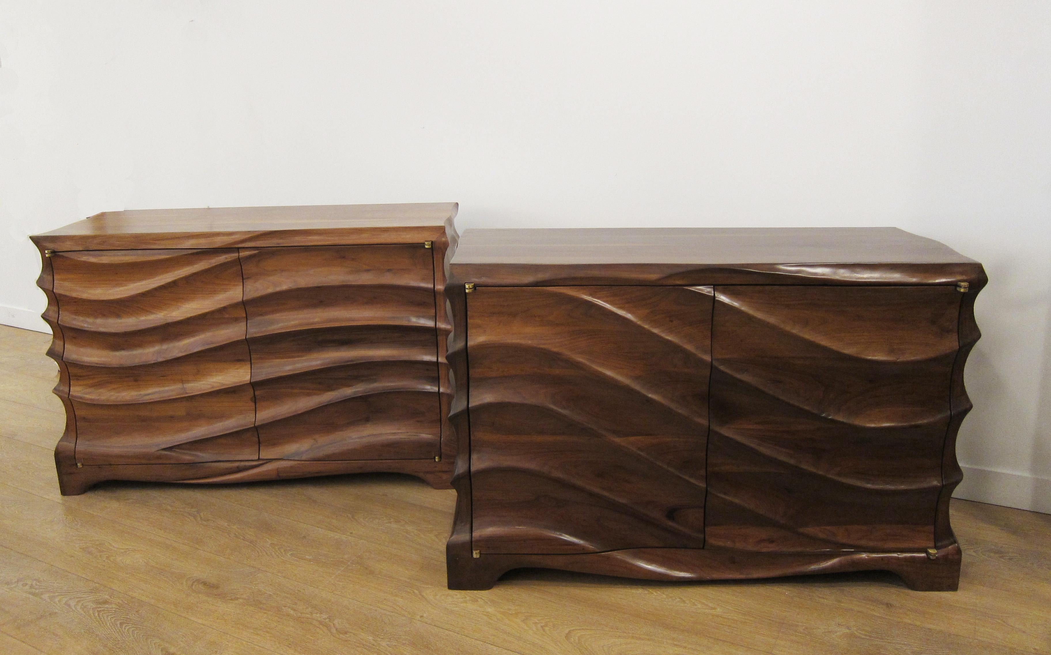 Unique near pair of hand carved walnut cabinets
Commissioned in solid black walnut to our local artist
These exceptional organic forms blur the line between sculpture and furniture.
Two-doors mounted on sculptural brass hinges concealing shelves on
