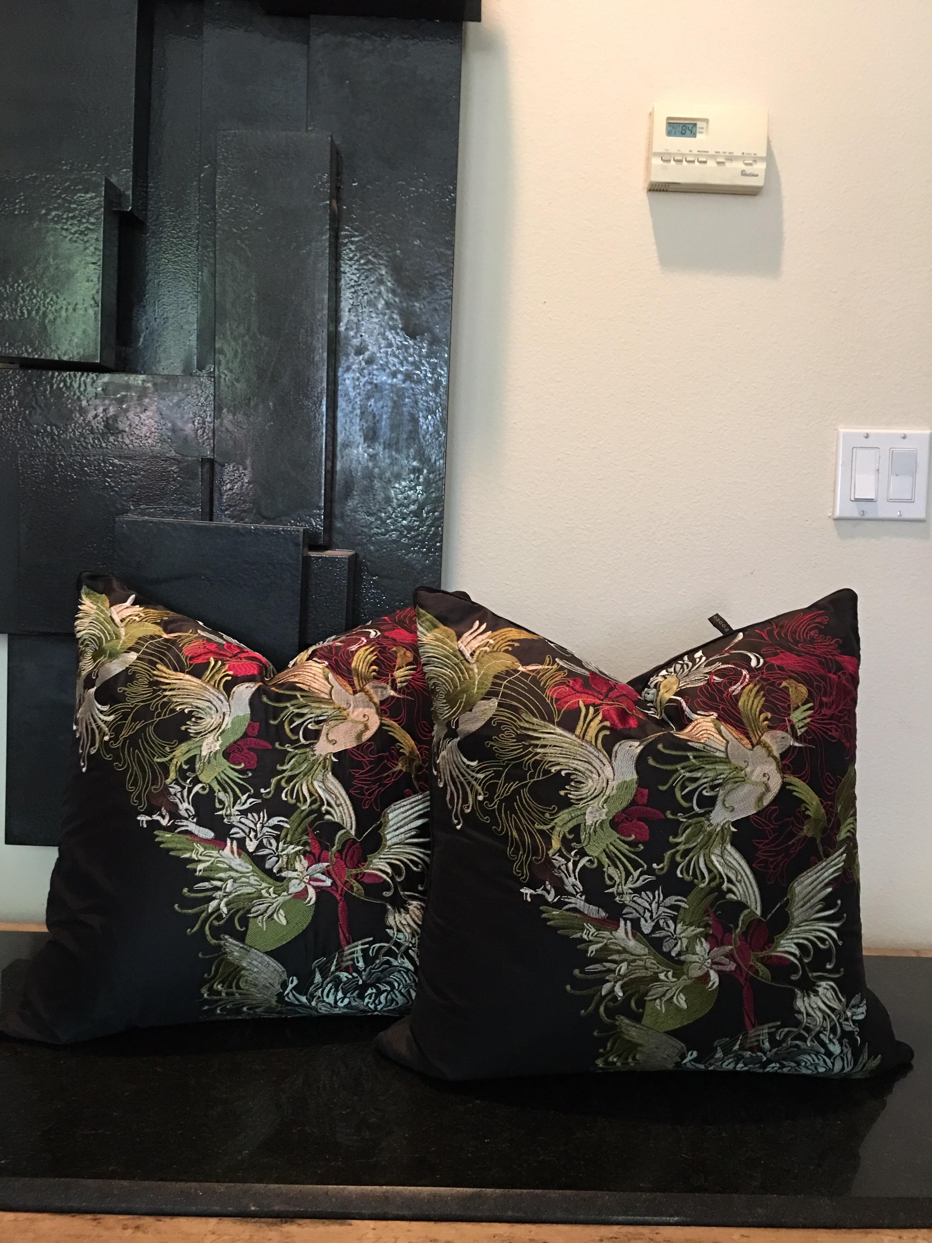 These very high-end pillows made by rodeo home of Beverly Hills were special ordered by a designer for a Palm Springs project but never used. High end faux black silk, they are intricately embroidered in citreon green, ruby and silvery white. Filled