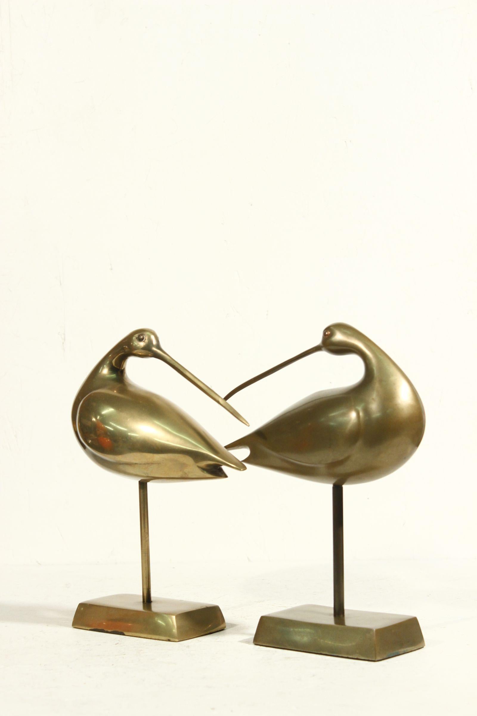 Pair of brass bird sculptures representing storks or cranes. 

In great overall condition, showing a nice patina of age. 

