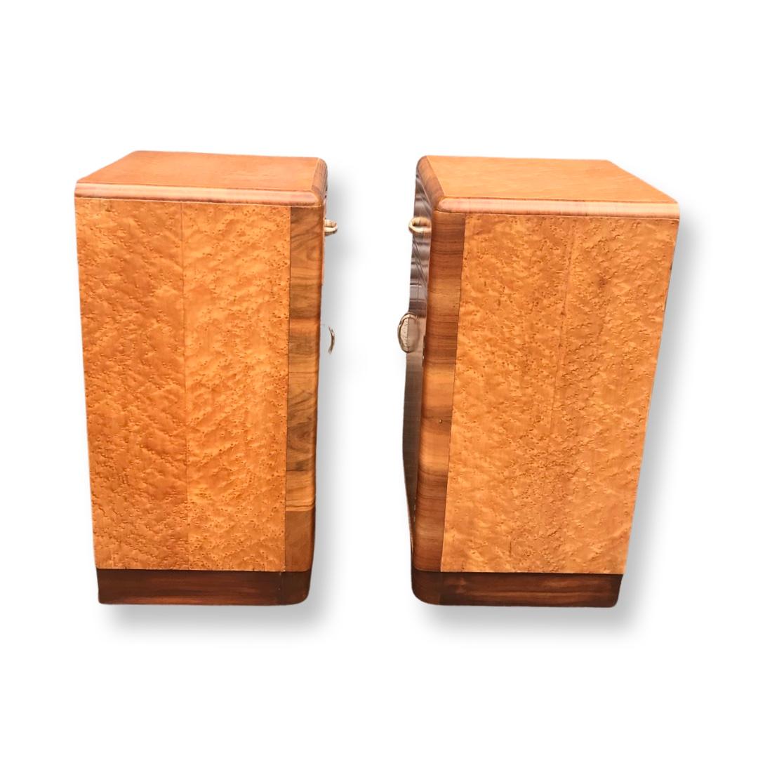 Beautiful pair of matching Birds eye maple bedside cabinets dating to Circa 1920/30. Typical of the Art Deco period these nightstands have original handles, (white phenolic with brass detailing) on the drawers and door fronts. They boast large top