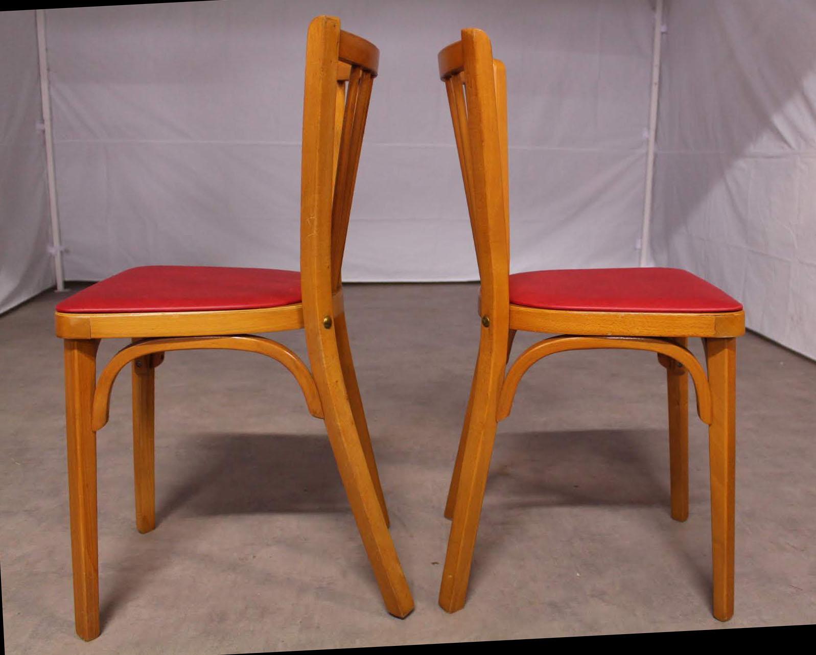 Pair of midcentury French Bistro dining chairs by Baumann, circa 1950
With original label still visible under one
Two side or dining chairs
Original vintage condition 
Frames are sound and solid.
Classic Beech bistro chairs made in France by