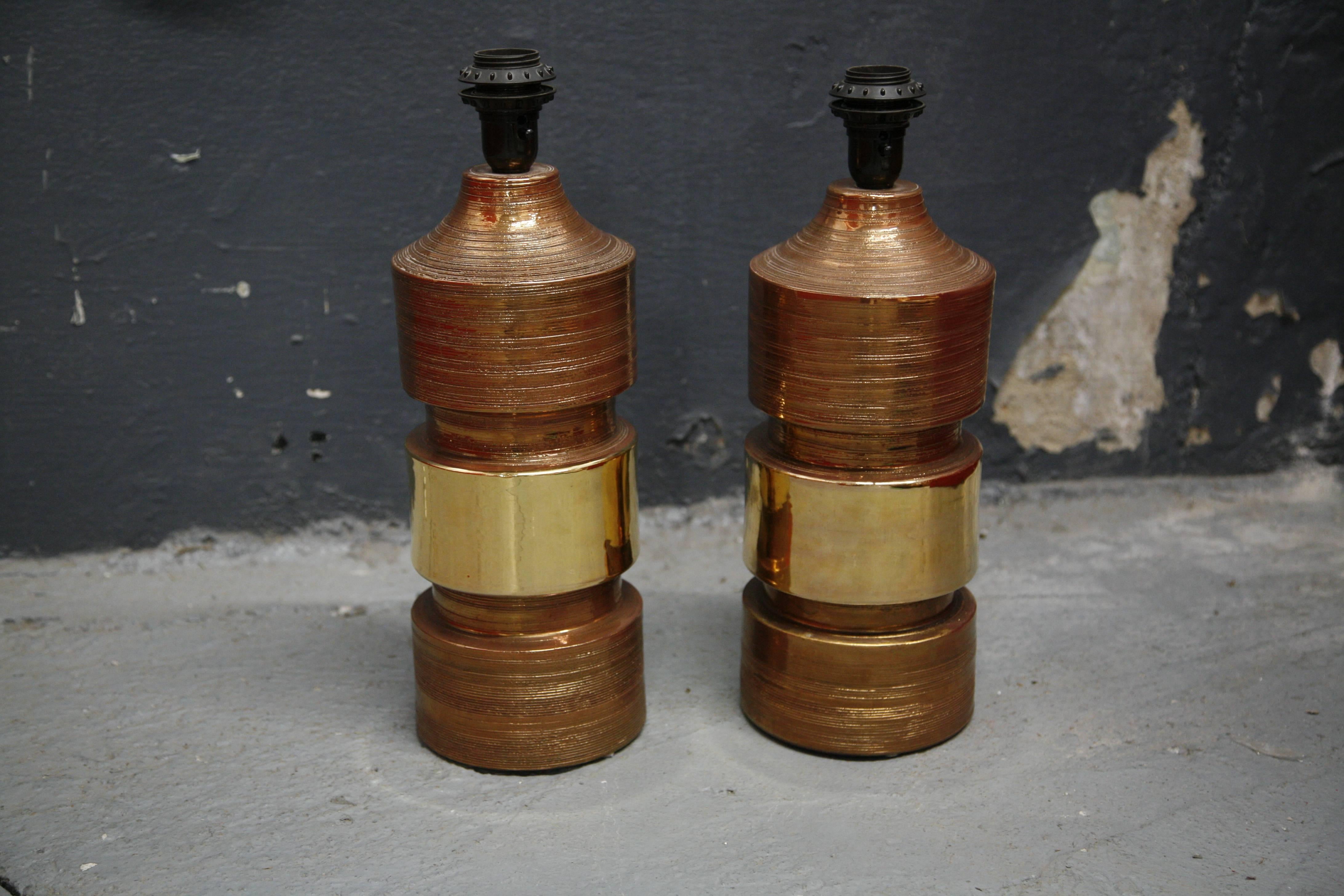 Bitossi lamps Italy 1970 ceramic copper and gold glaze by Bitossi has stickers from Bergboms as they were sold by Bergboms, Sweden.
Very strong powerful bodies with such elegant glaze sort of a matte finish except from the gold stripe in the middle