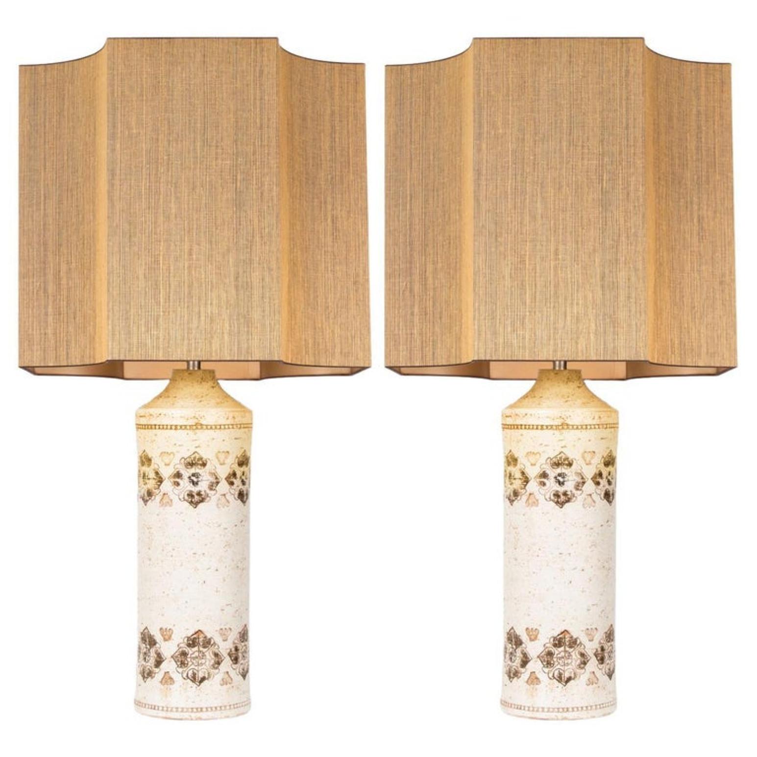 Pair of this Bitossi lamp features a ceramic base with a white glaze in the and patterns of brown, Bitossi, Italy, circa 1960s. With an exceptional new custom made shades by René Houben. With warm gold inner-shade.

Approximate dimensions: Ceramic