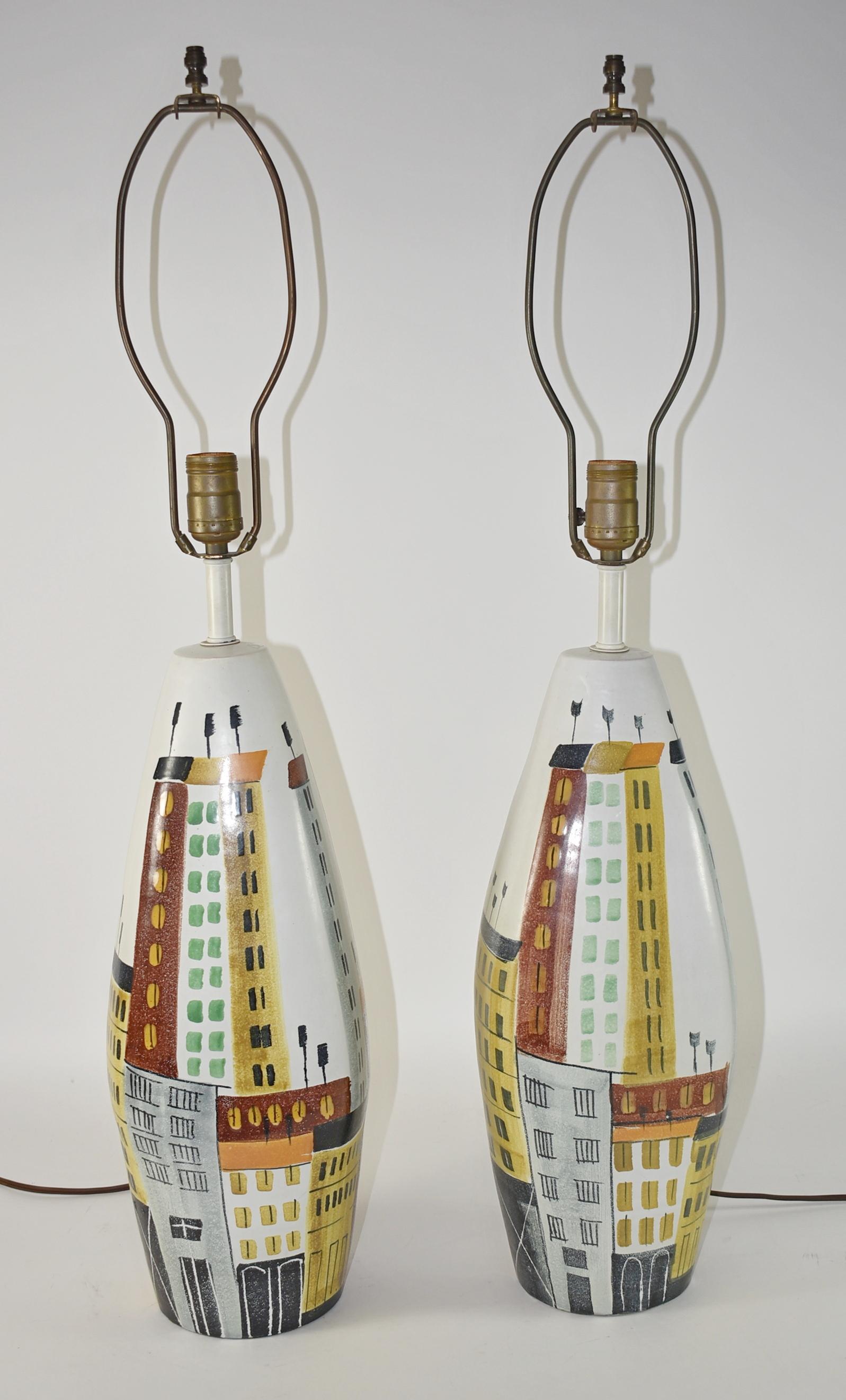 Pair of Bitossi Raymor Italian Cityscape ceramic table lamps. circa 1960s. Mid-Century Modern Style. The company was incorporated by Guido Bitossi in 1921, though the family began making art pottery in the Mid-19th century. Hand decorated city scene