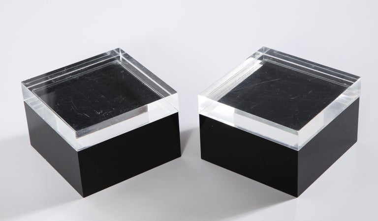 A pair of 1970s modernist Lucite small decorative boxes with black acrylic bases and clear lids. Perfect as a trinket or jewelry box.