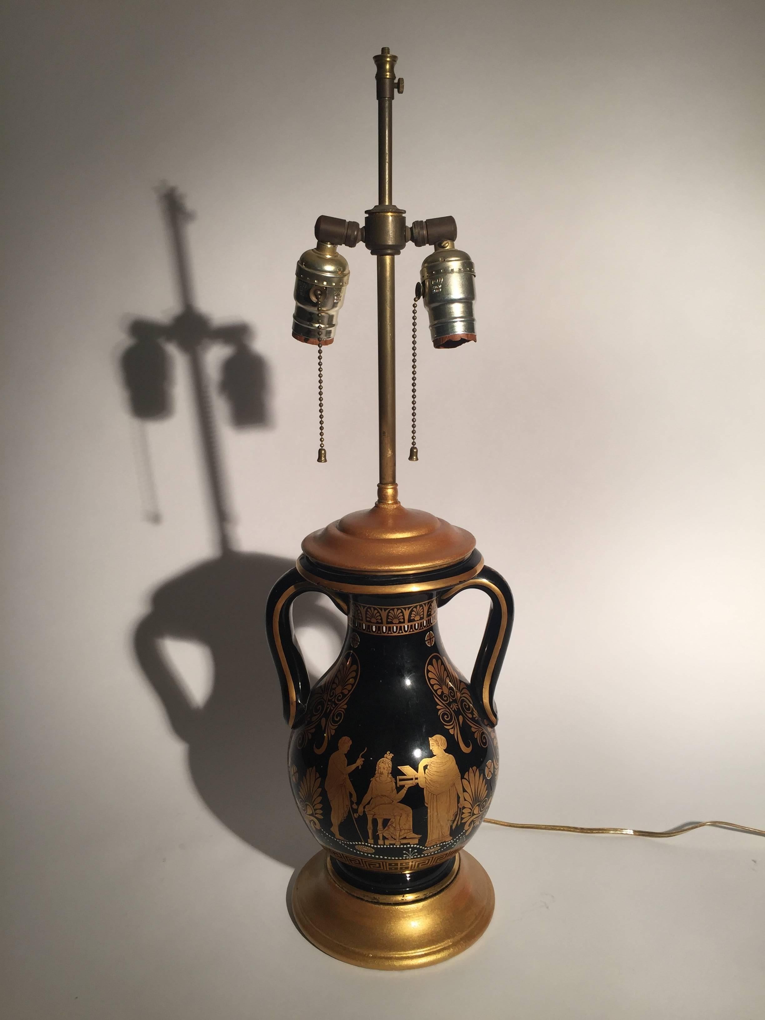 A pair of rare back and gold Greek revival handled urn lamps with gilt decoration. The bodies with draped Greek figures and Greek key and hand applied white bead decoration. The double sockets with an adjustable shade height. The shades are for