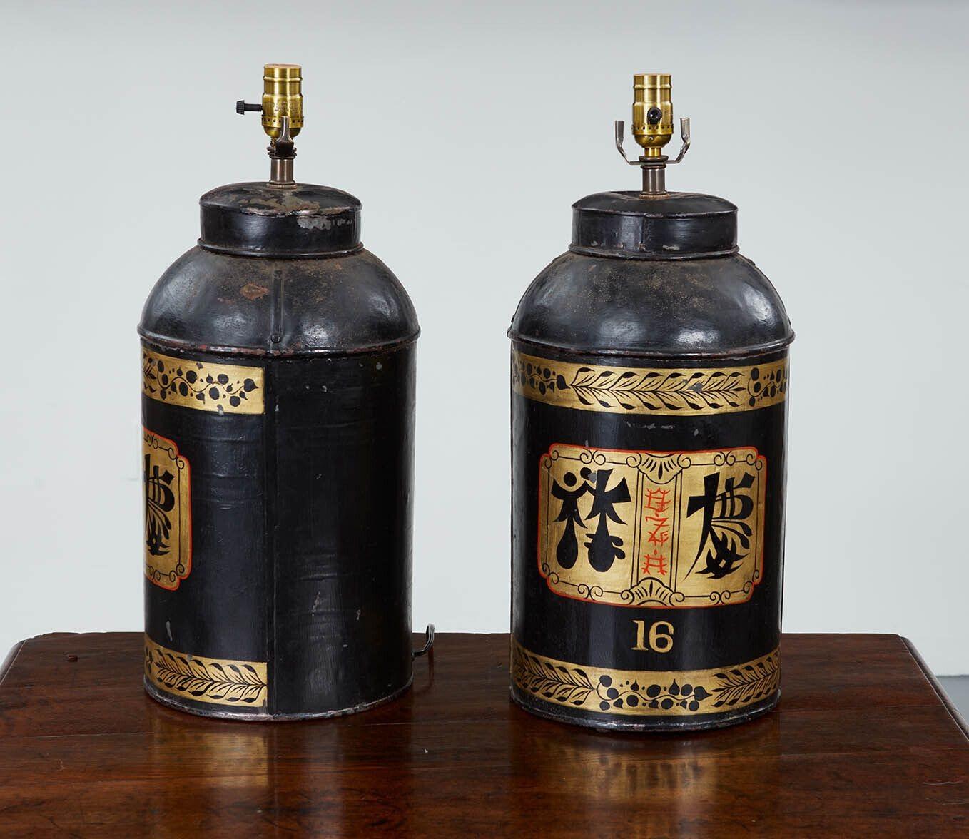 Good pair of English Victorian black painted tea tins, circa 1880, now as lamps.