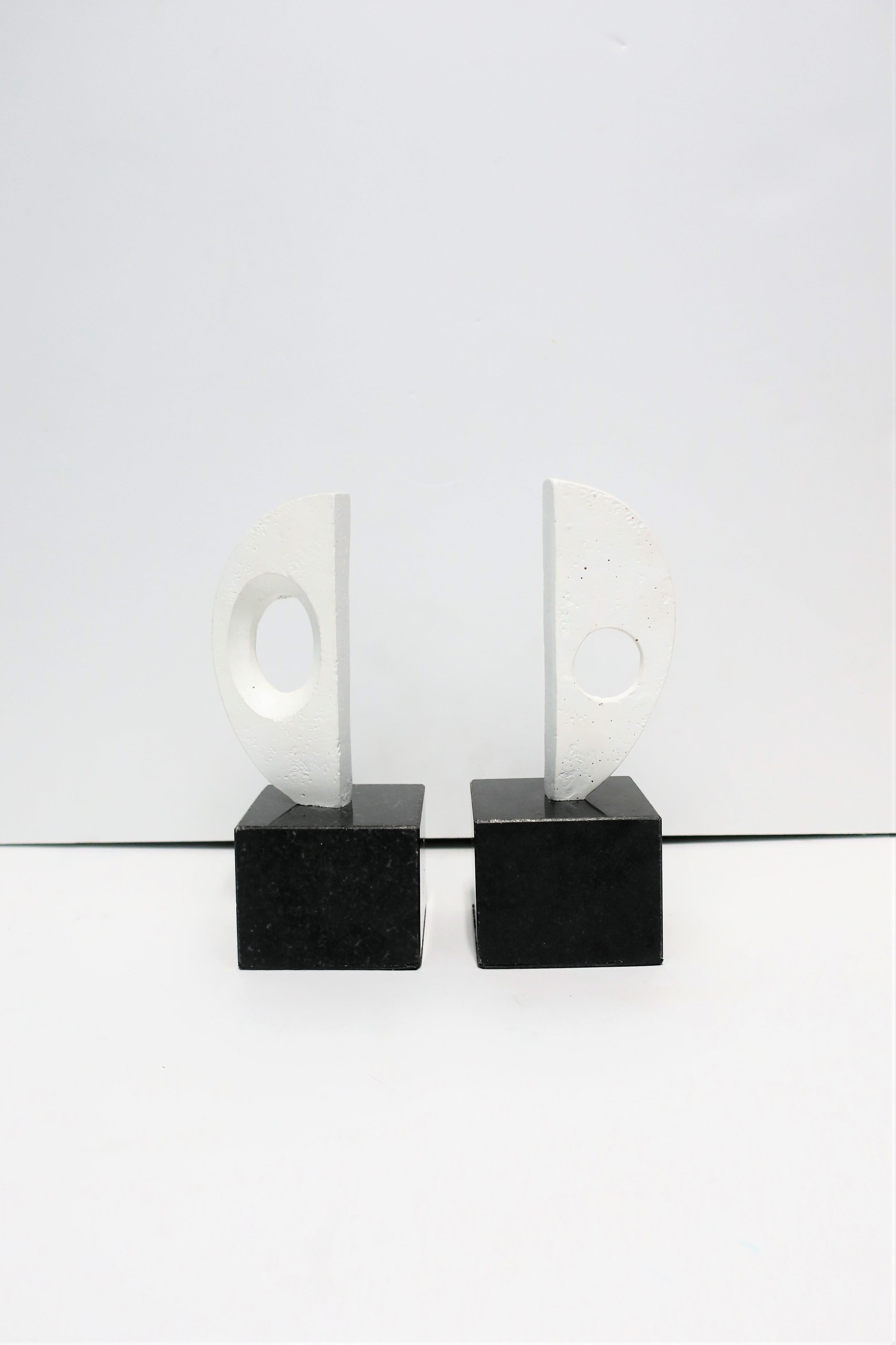 A substantial pair of black and white abstract white plaster sculpture bookends on black marble or granite bases. Pair demonstrated as bookends in image #5. Pair also works well as decorative objects/sculptures as show in images #6 and 7 on small