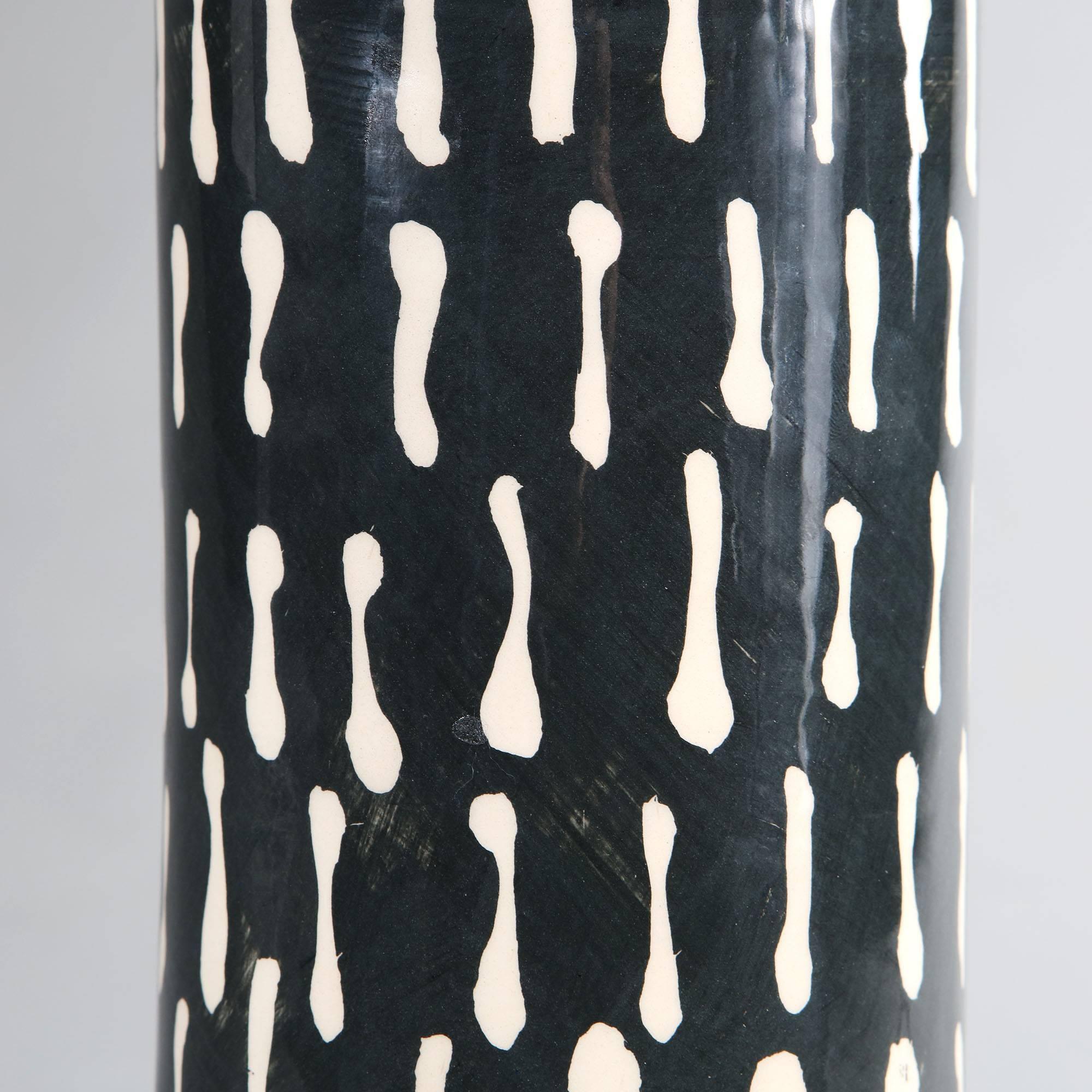 A pair of studio pottery vases, now converted as lamps, with a black and white patterned glaze and contrasting orange rims.

Please note: Lampshades not included.

Currently wired for the UK. Please enquire for rewiring services.