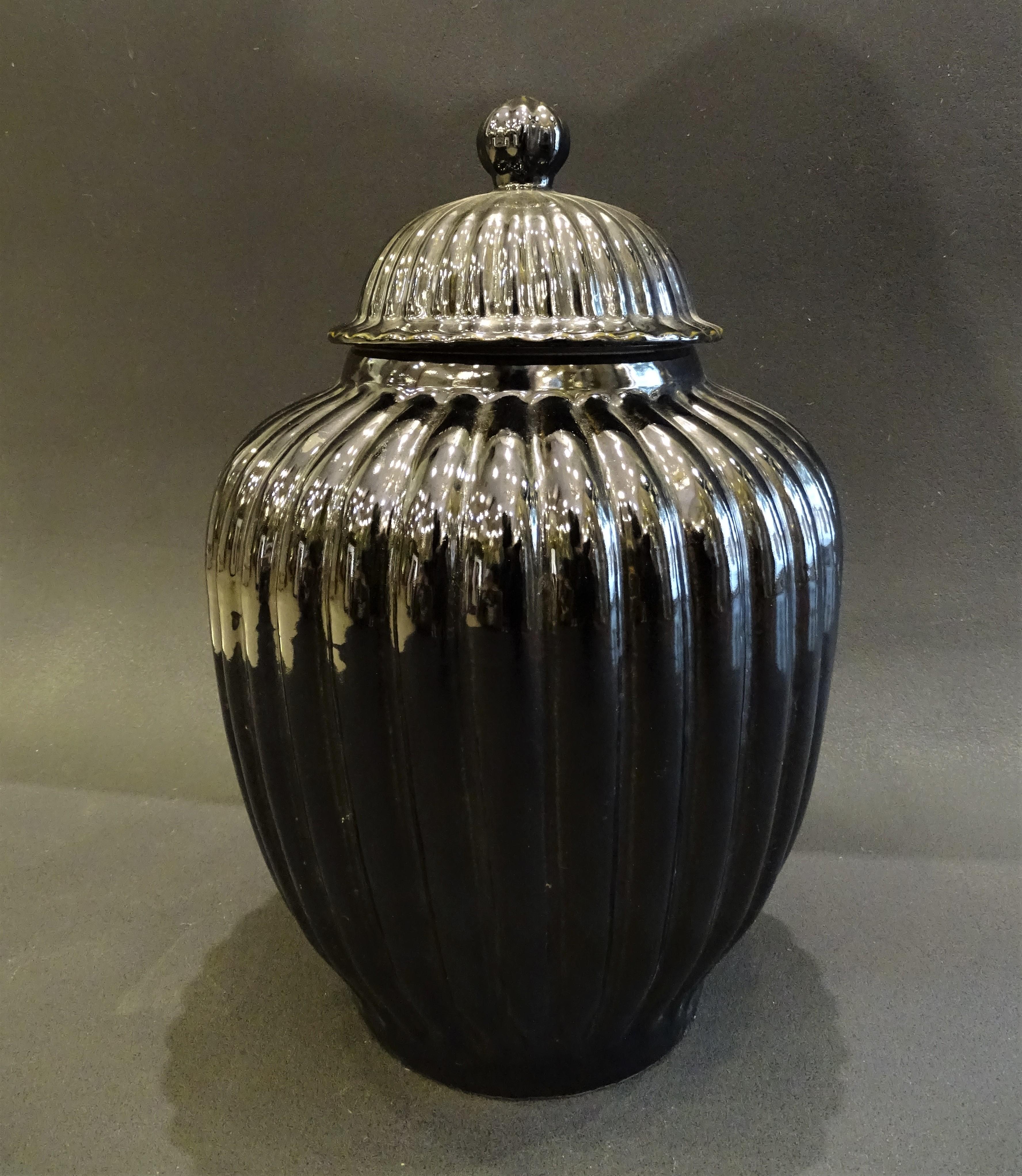 Amazing pair of Italian black  vases or Bucaros with lid ,in black ceramic , large in size and of great decorative strength in their shapes. The pieces are made by hand, so each piece has a unique finish.

 They are two pieces of high decorative and