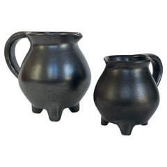 Pair of black ceramic tripod pitcher
