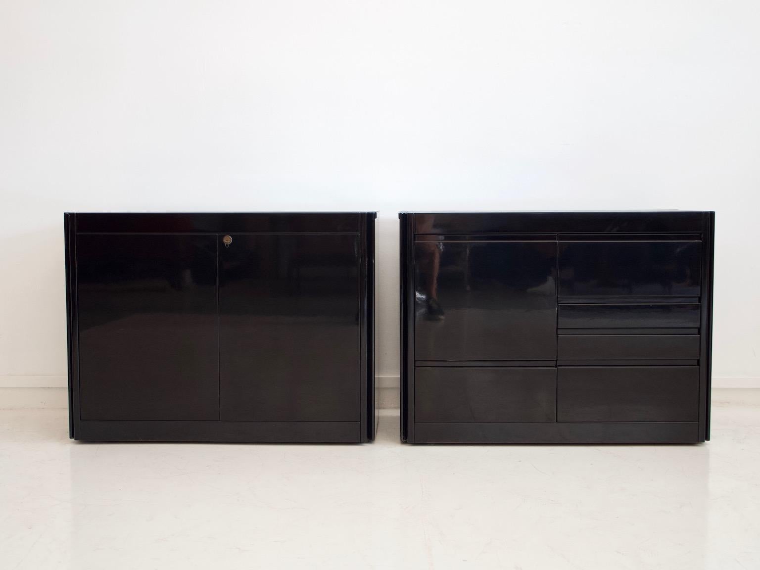 Pair of laminated wood credenzas with marble top, designed by Angelo Mangiarotti. Produced by Tisettanta in the 1970s. One of them with drawers, the other one with shelves behind two doors. The sideboards have been restored and lacquered in black.