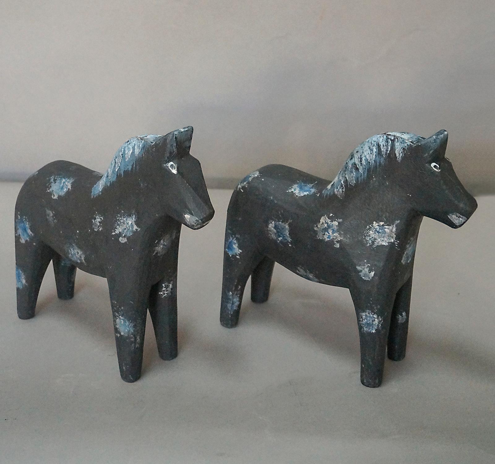 Pair of hand carved Dala horses, Sweden circa 1910, in black paint. Great expressions on these.