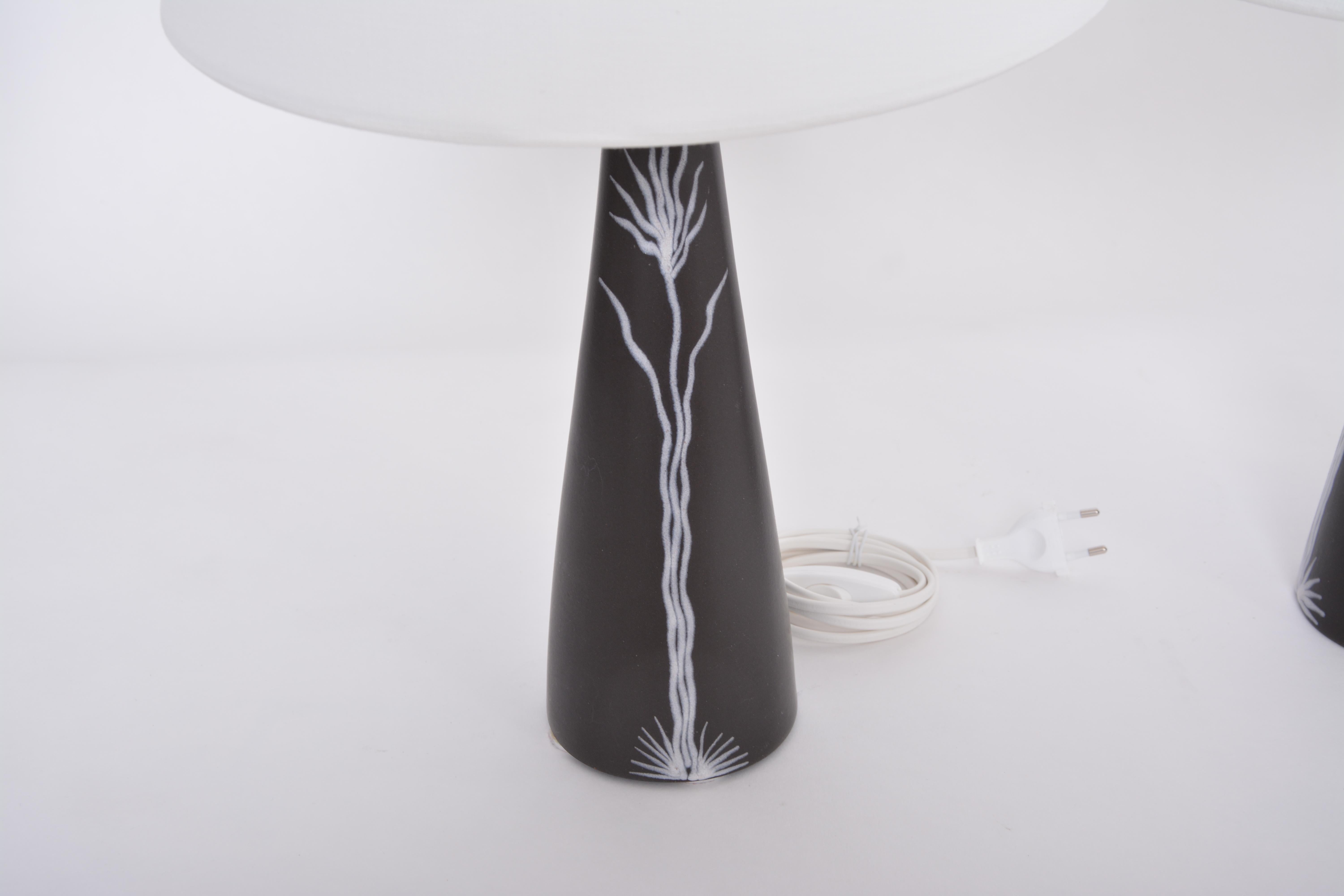 Pair of black Danish midcentury Ceramic table lamps by Holm Sorensen for Søholm

These beautiful table lamps were designed by Holm Sørensen and Svend Aage Jensen for Danish company Søholm. The design is from their series 