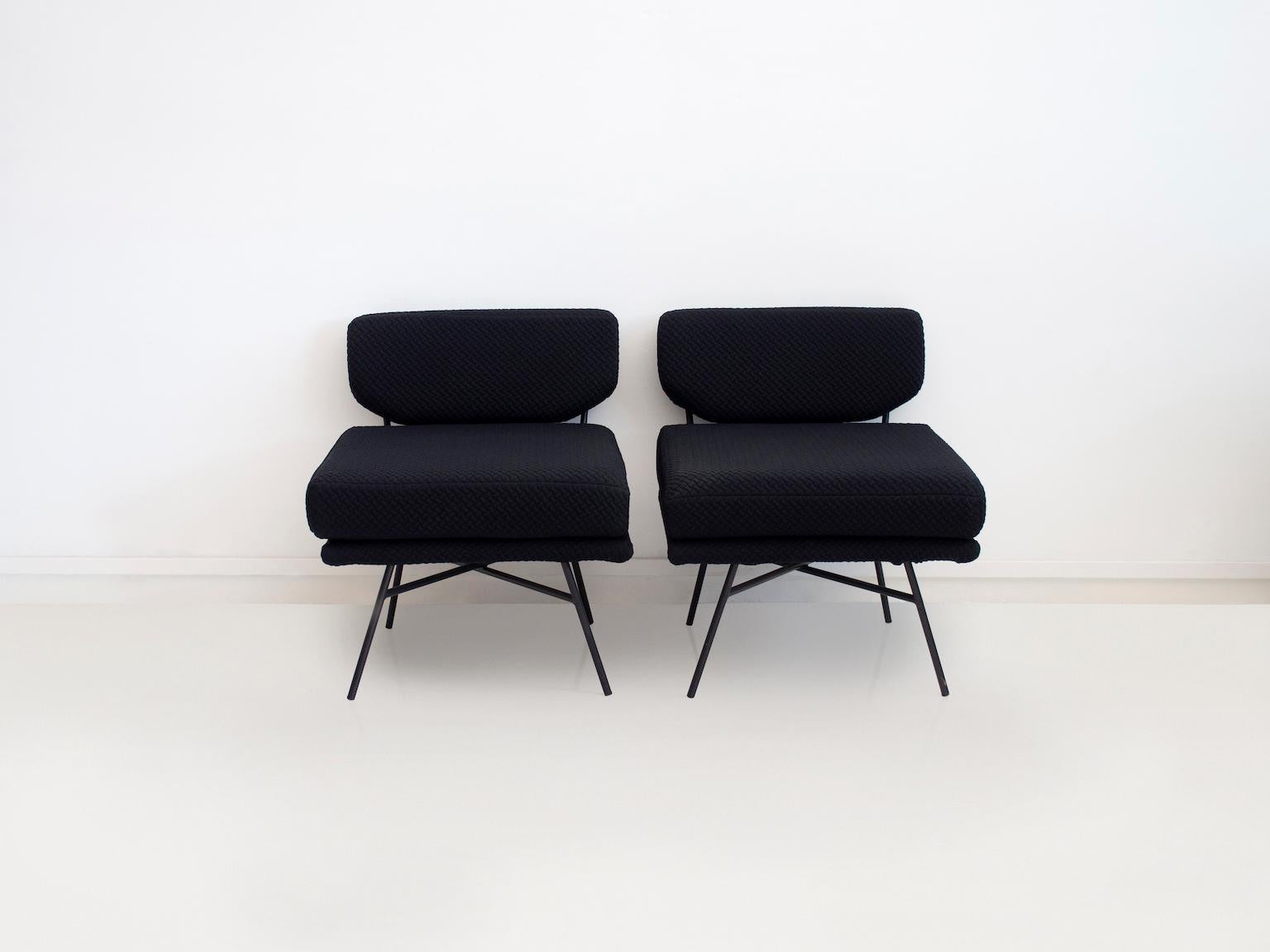 Pair of 'Elettra' chairs originally designed by B.B.P.R. in 1954, Italy. This pair of lounge chairs is produced by Arflex circa 2018, featuring black tubular steel frame and black embossed fabric upholstery.

The 'Elettra' lounge chair won the