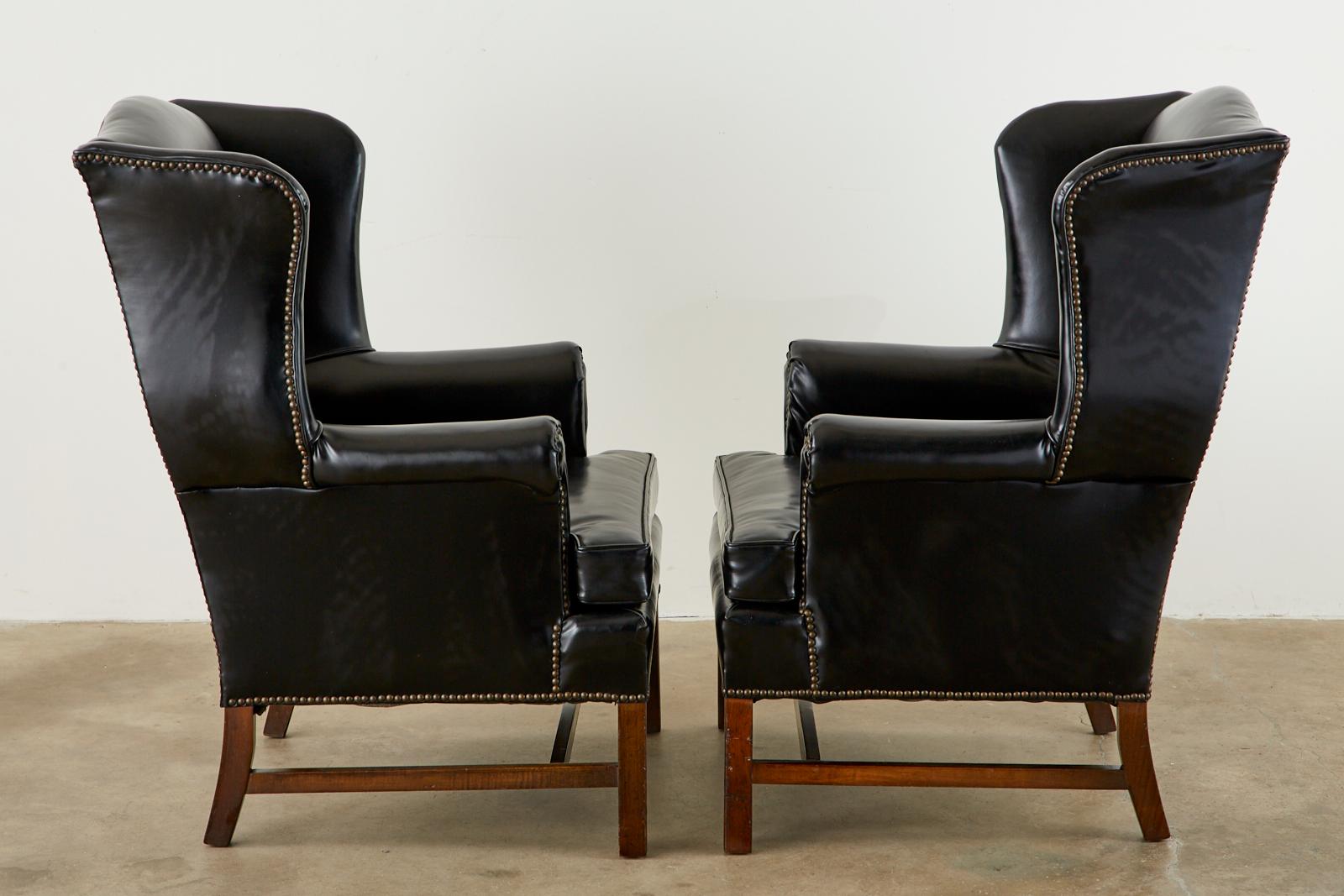 20th Century Pair of Black English Georgian Style Mahogany Wingbacks