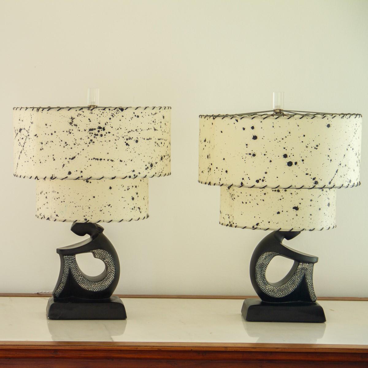 A small pair of black figurative chalkware lamps depicting a crouching male and female with white painted textured detail.

The lamps are stamped F.A.I.P (Fine Arts in Plastic) to the rear. The majority of F.A.I.P lamps were produced by art
