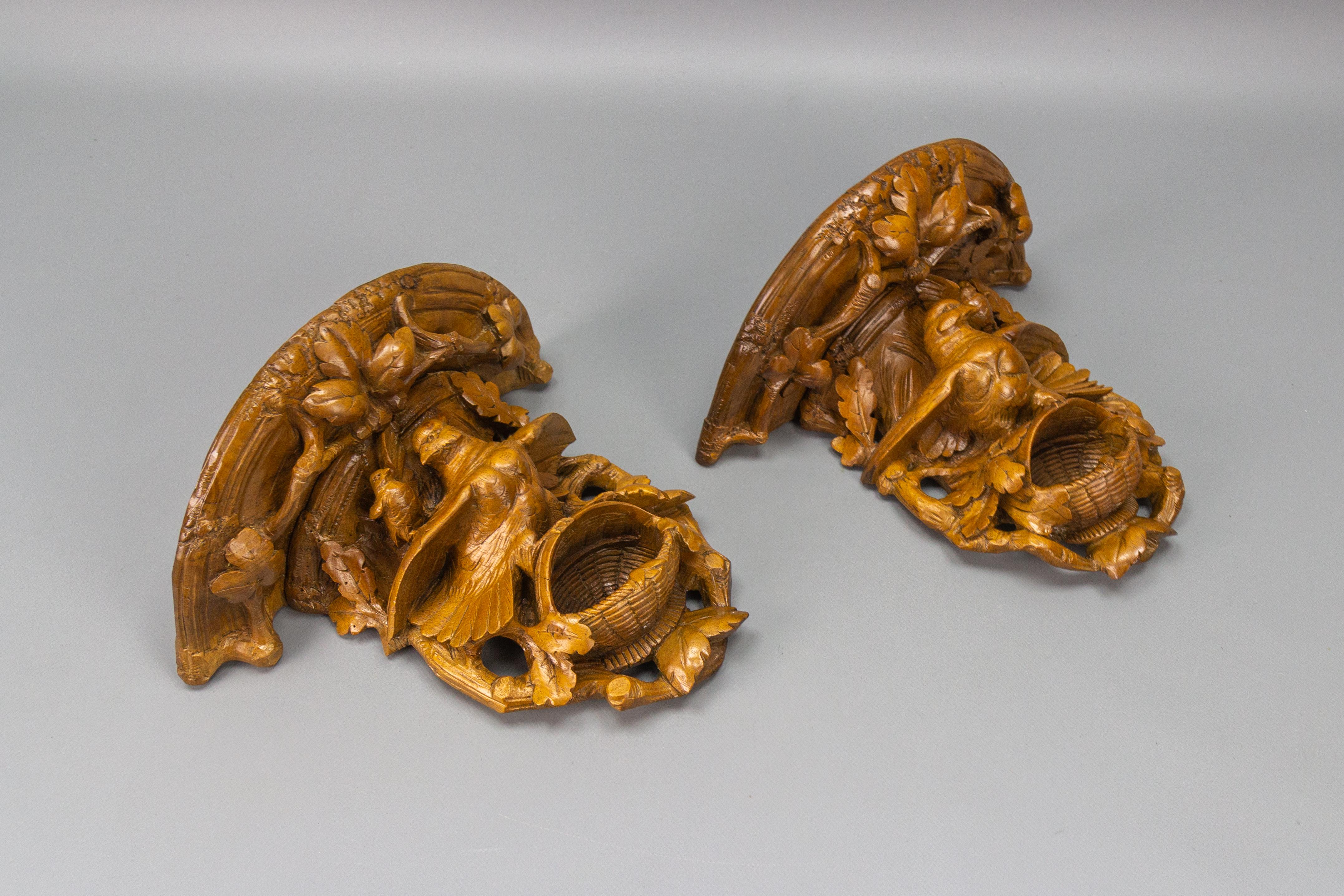 German Pair of Black Forest Carved Walnut Bird Nest Wall-Mounted Consoles, ca. 1920 For Sale