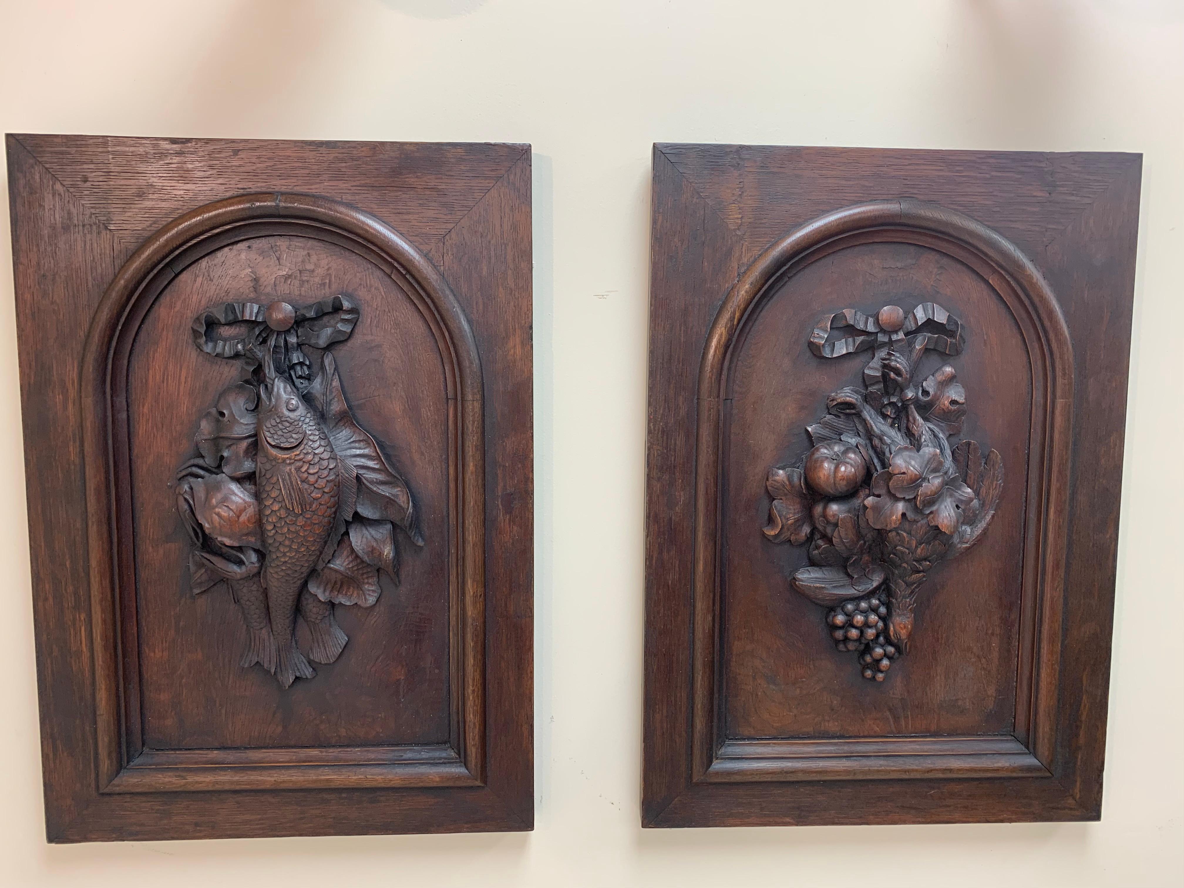 Pair of Black Forest style wall plaques C.1880’s. Each plaque displays beautifully detailed wood carvings, first photo consists of a fish carving and the other plaque consists of a bird carving. Extraordinary craftmanship and detail in each of the
