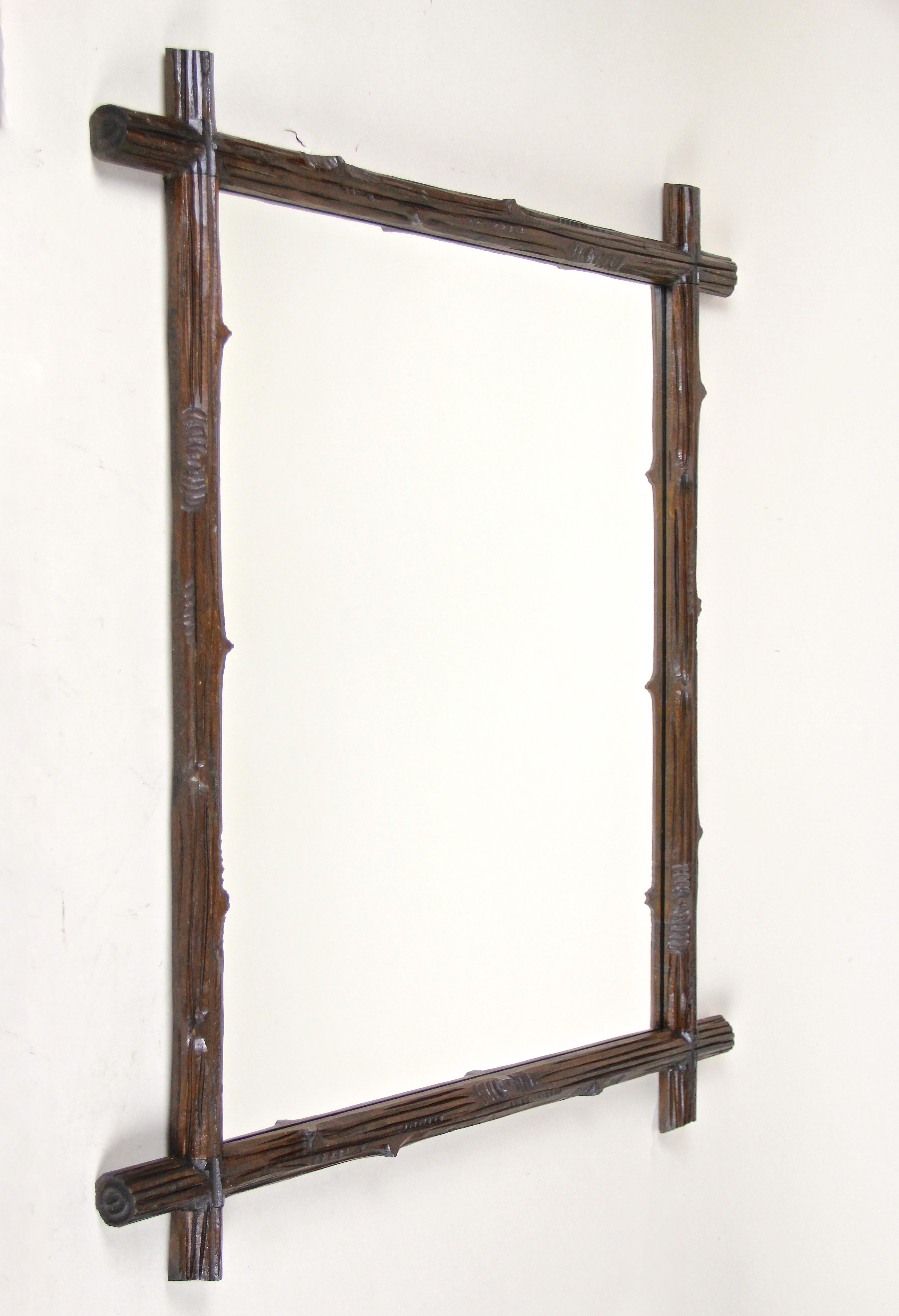 Wonderful pair of Black Forest wall mirrors out of Austria, circa 1880. These unique rustic wooden wall mirrors have been artfully hand carved out of basswood. The frames with protruding corners and a very own 