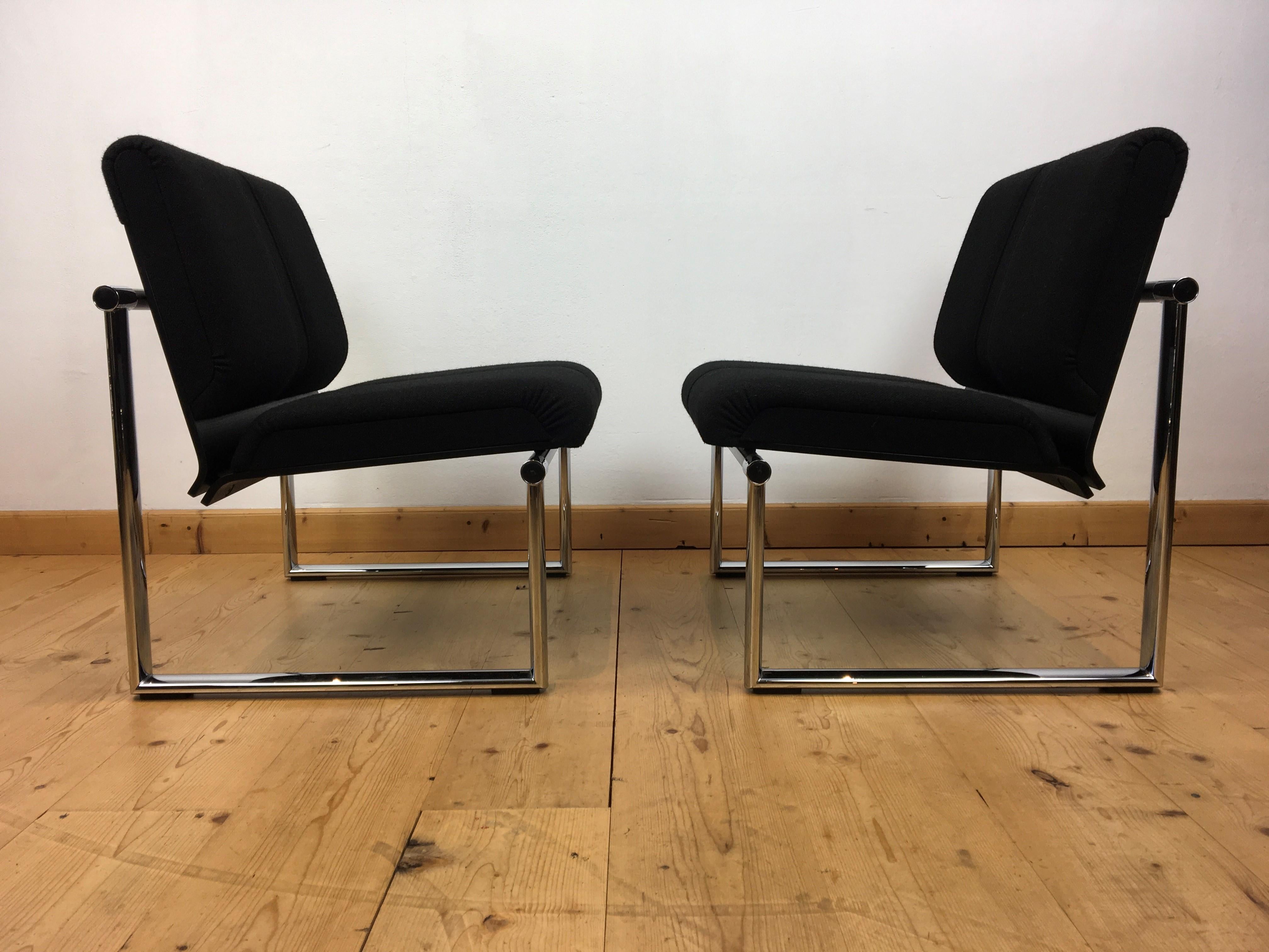 Set of 2 vintage design armchairs by Albert Stohl for GIROFLEX AG. 
These club chairs date circa 1980s - 1990s.
Both with original labels.

This large good quality armchairs have a chromed metal frame with black fabric seating with a seam in the