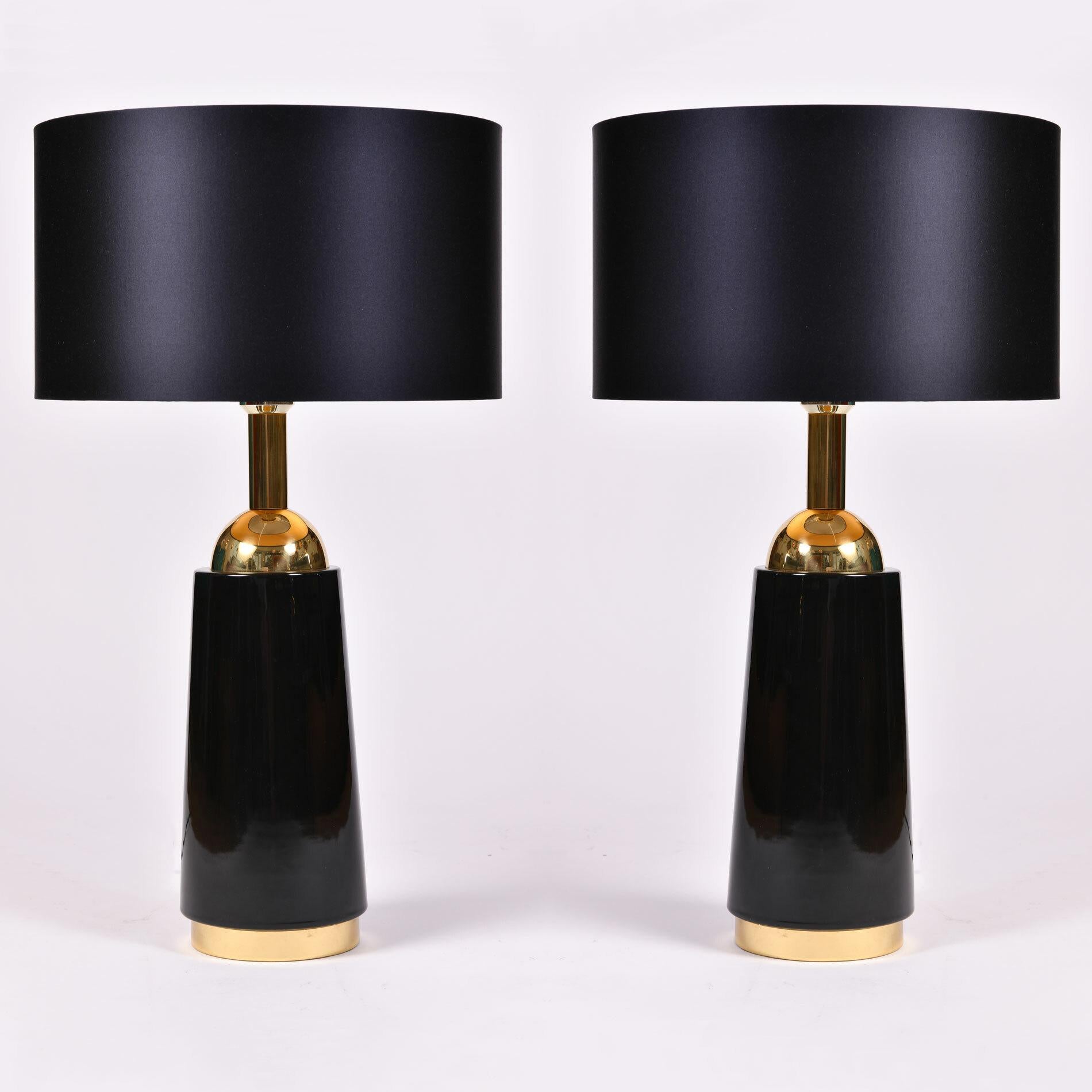 Elegant pair of Bergboms table lamps. Simple black glass base is trimmed with inset brass base and curved brass top and fitting. 

Please note with the lampshade the total height is 60.5cm and diameter is 36cm.