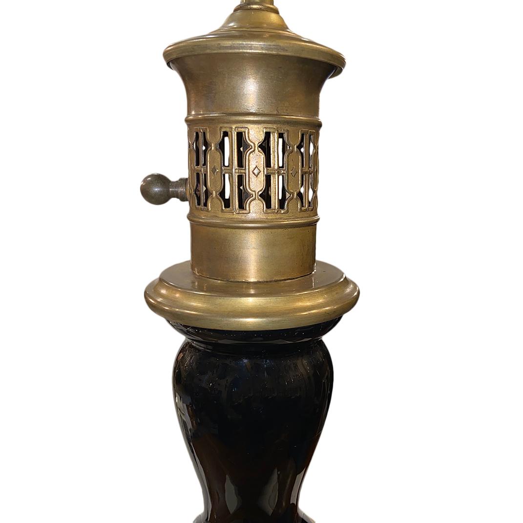 A pair of circa 1920s French black glass table lamps with bronze bases.

Measurements:
Height of body 19