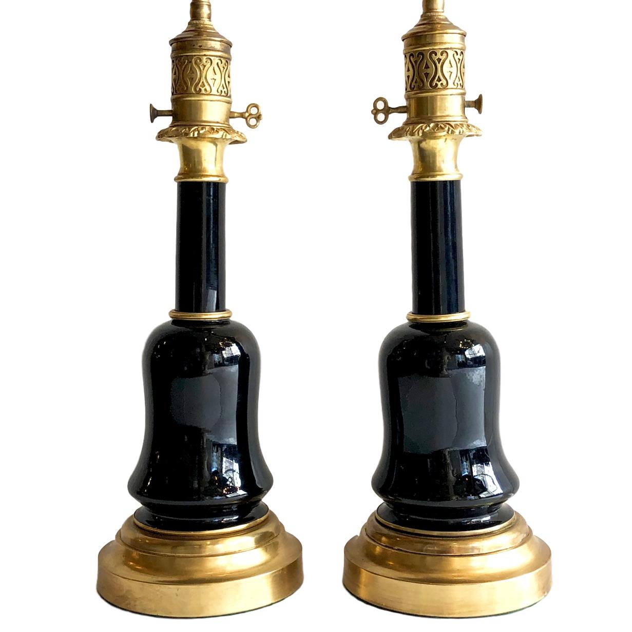 A pair of circa 1900 French black glass oil lamps converted to electrified table lamps.

Measurements:
Height of body: 17