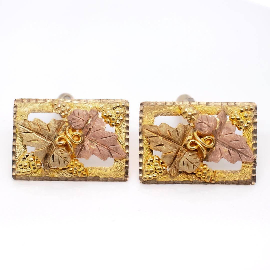 A fine signed pair of signed Black Hills cufflinks.

The heads in 10k and 12K yellow and pink golds that are set on gold-filled posts.

With grape & grape leaf designs to the heads.

Marked for Landstrom's to the reverse.

Simply a wonderful pair of