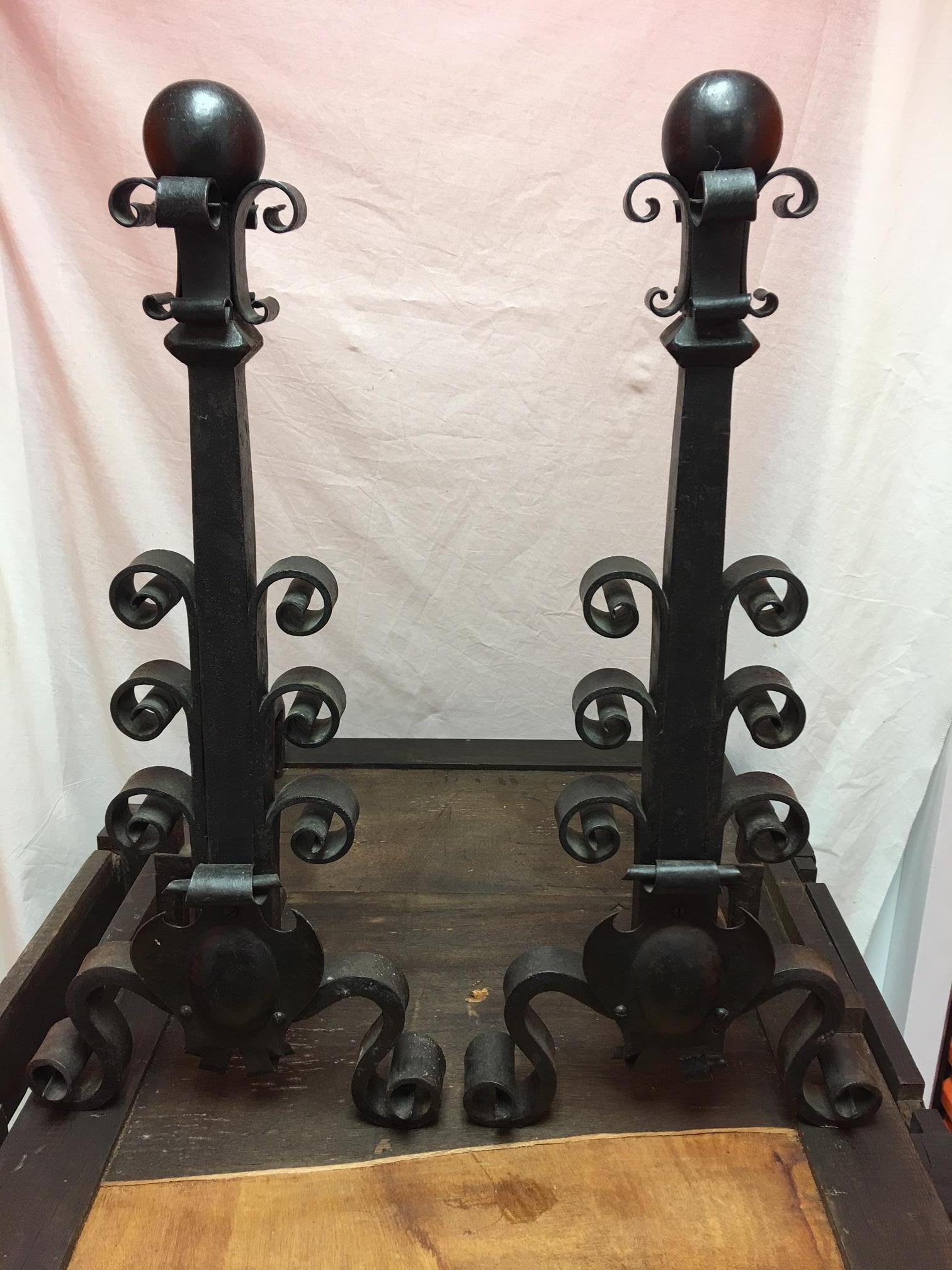 Pair of black iron column andirons, 19th century.