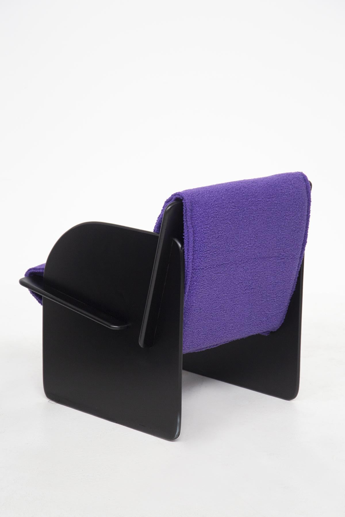 Pair of black Italian armchairs with purple bouclé from the 1960s. The pair of armchairs are of Italian manufacture and made of black painted wood. The pair of armchairs have recently been reupholstered in purple bouclé fabric. The particularity of