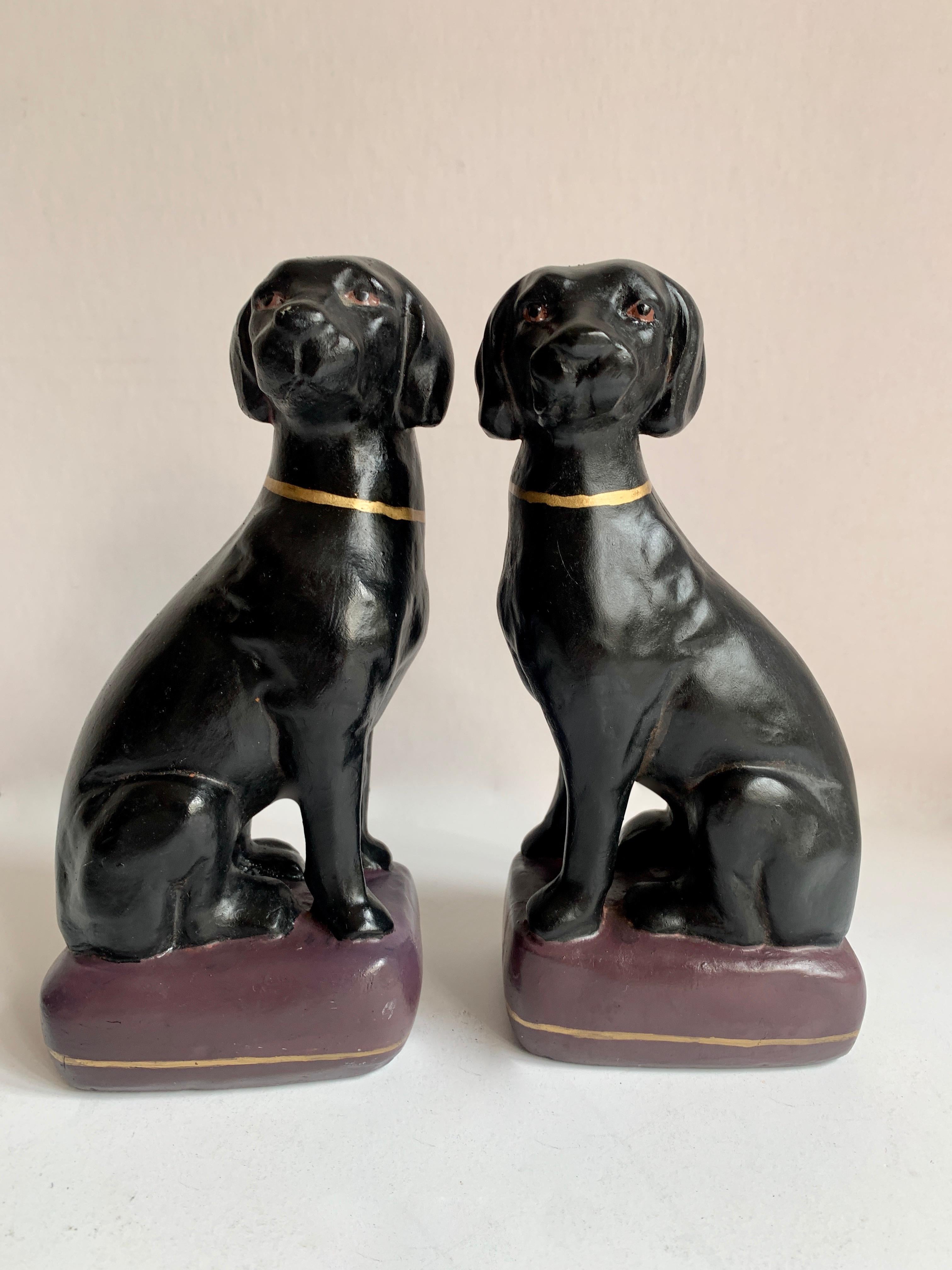 Pair of black Labrador retriever bookends - a wonderful pair of black labs sitting on a gilt purple pillow with a matching gilt collar. The pair will compliment any shelf and hold your favorite books. Also, a nice addition to the childs room!