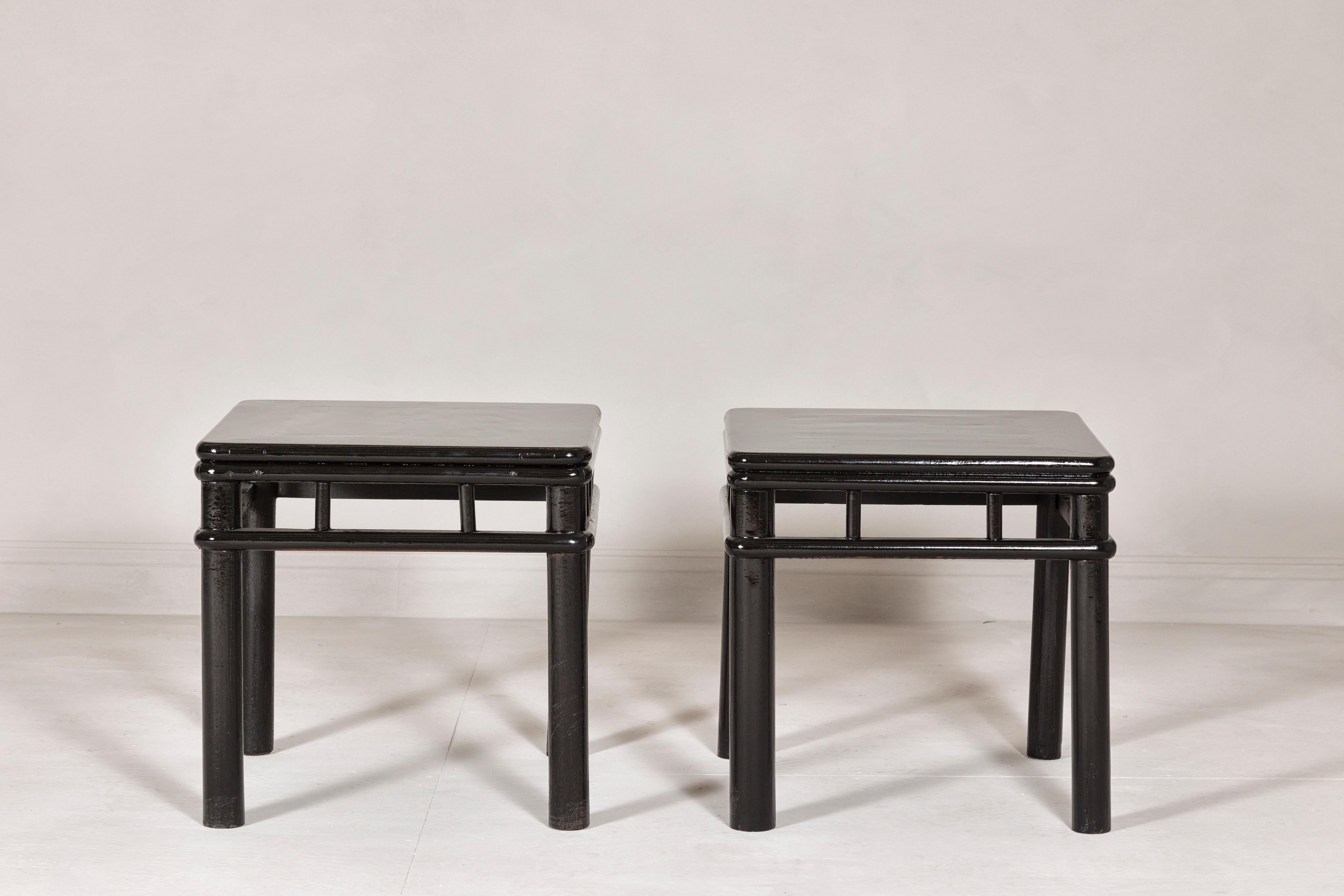 Qing Pair of Black Lacquer Drinks Tables with Open Stretcher and Cylindrical Legs For Sale