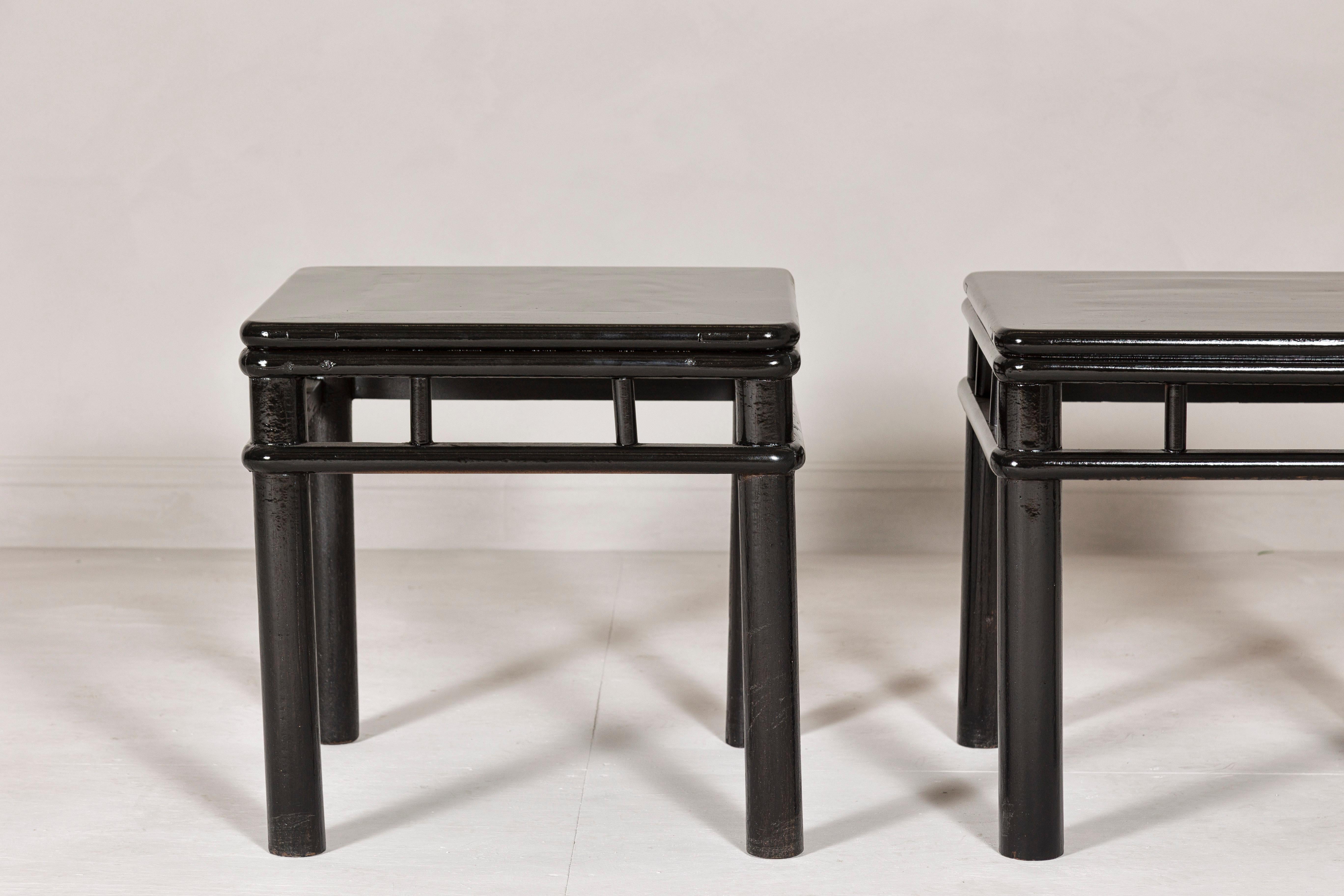Chinese Pair of Black Lacquer Drinks Tables with Open Stretcher and Cylindrical Legs For Sale