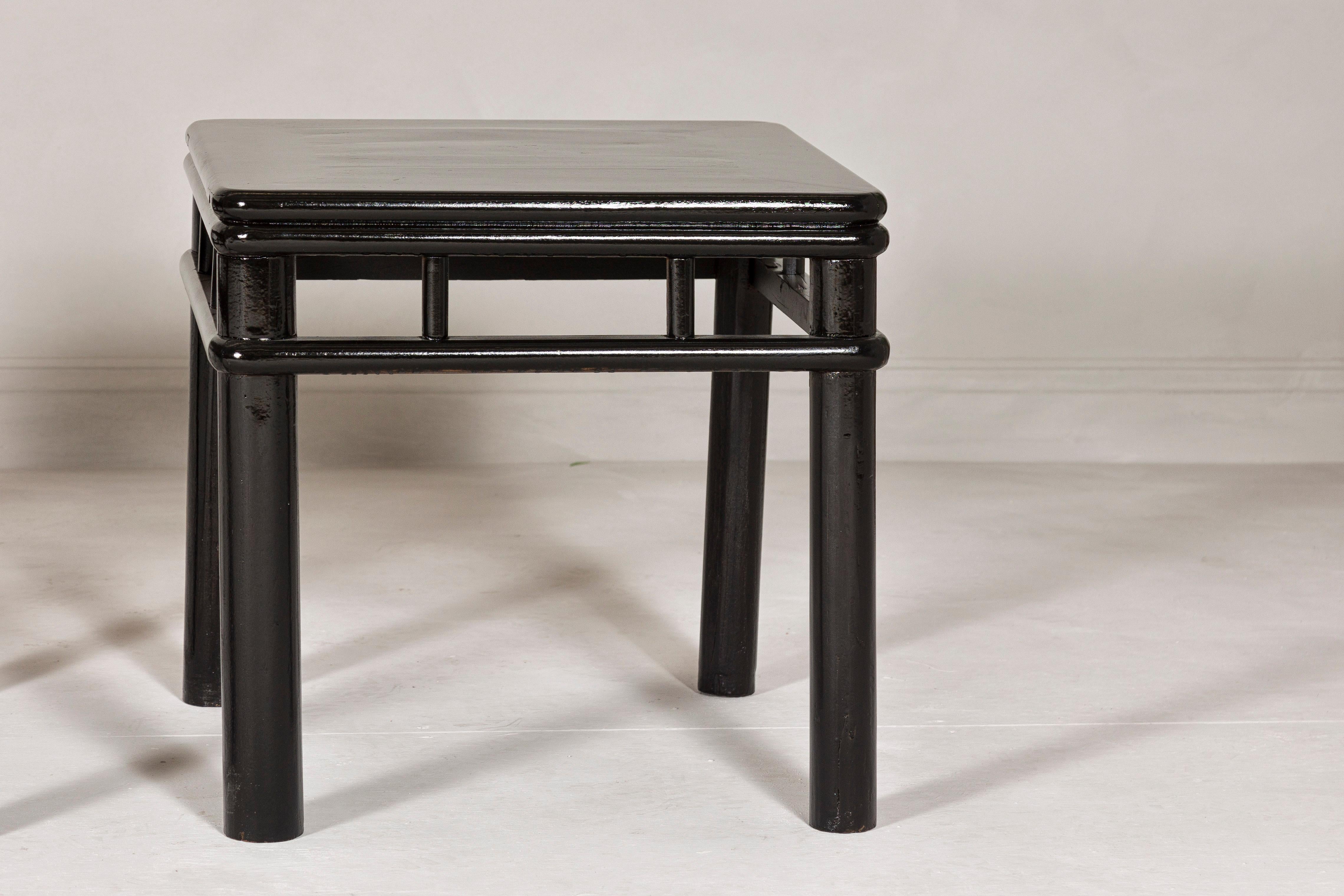 Carved Pair of Black Lacquer Drinks Tables with Open Stretcher and Cylindrical Legs For Sale