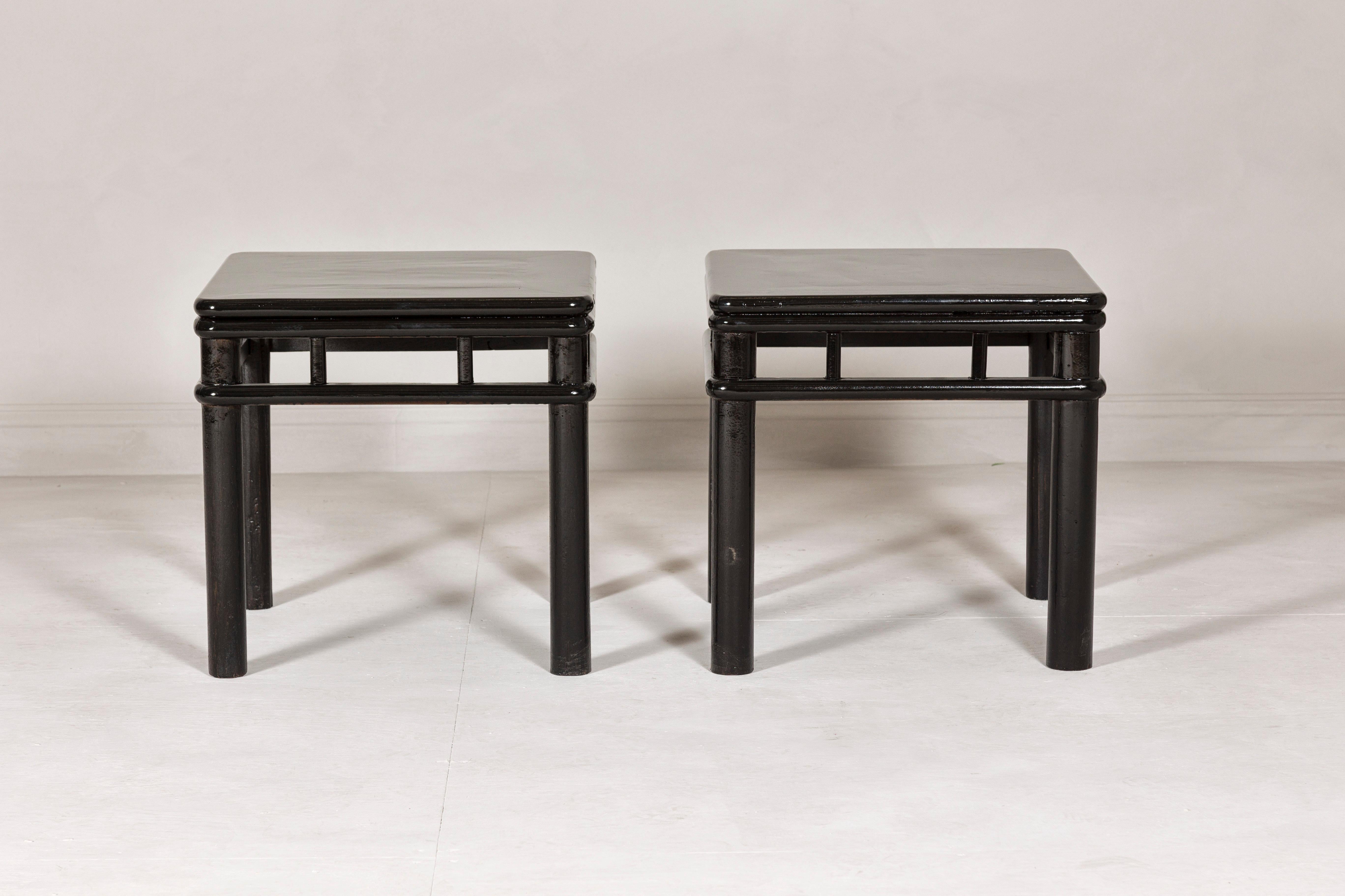 20th Century Pair of Black Lacquer Drinks Tables with Open Stretcher and Cylindrical Legs For Sale