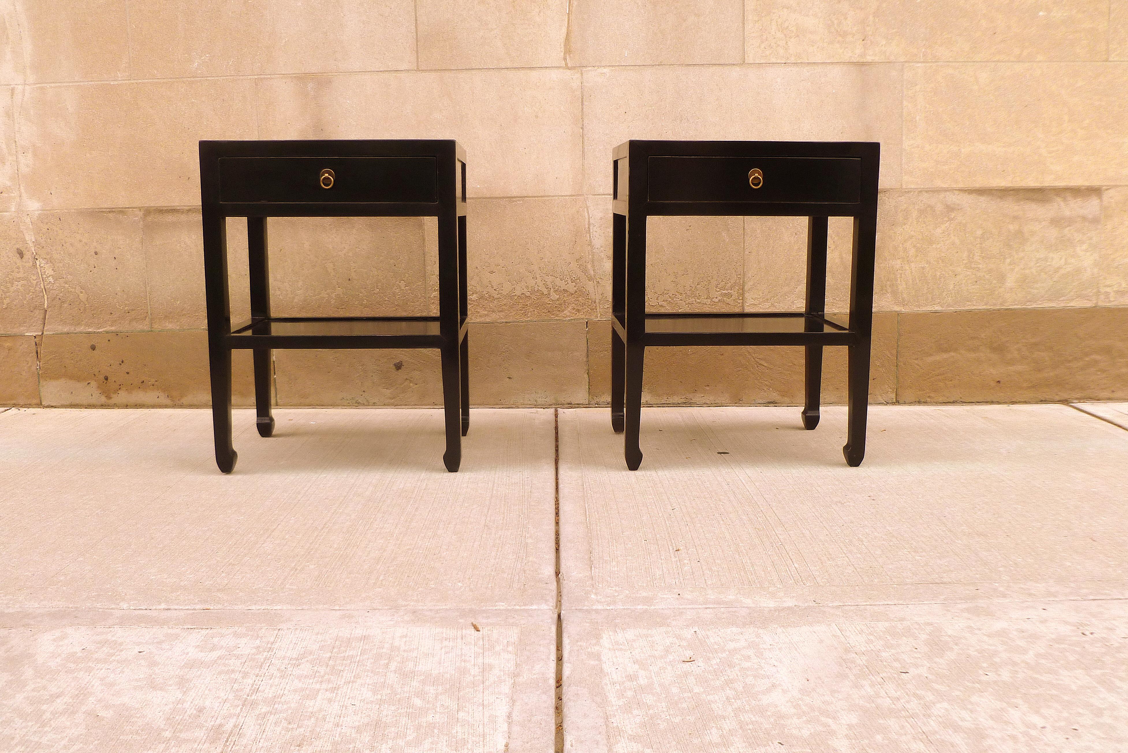 Pair of black lacquer end tables, with drawers and shelf.